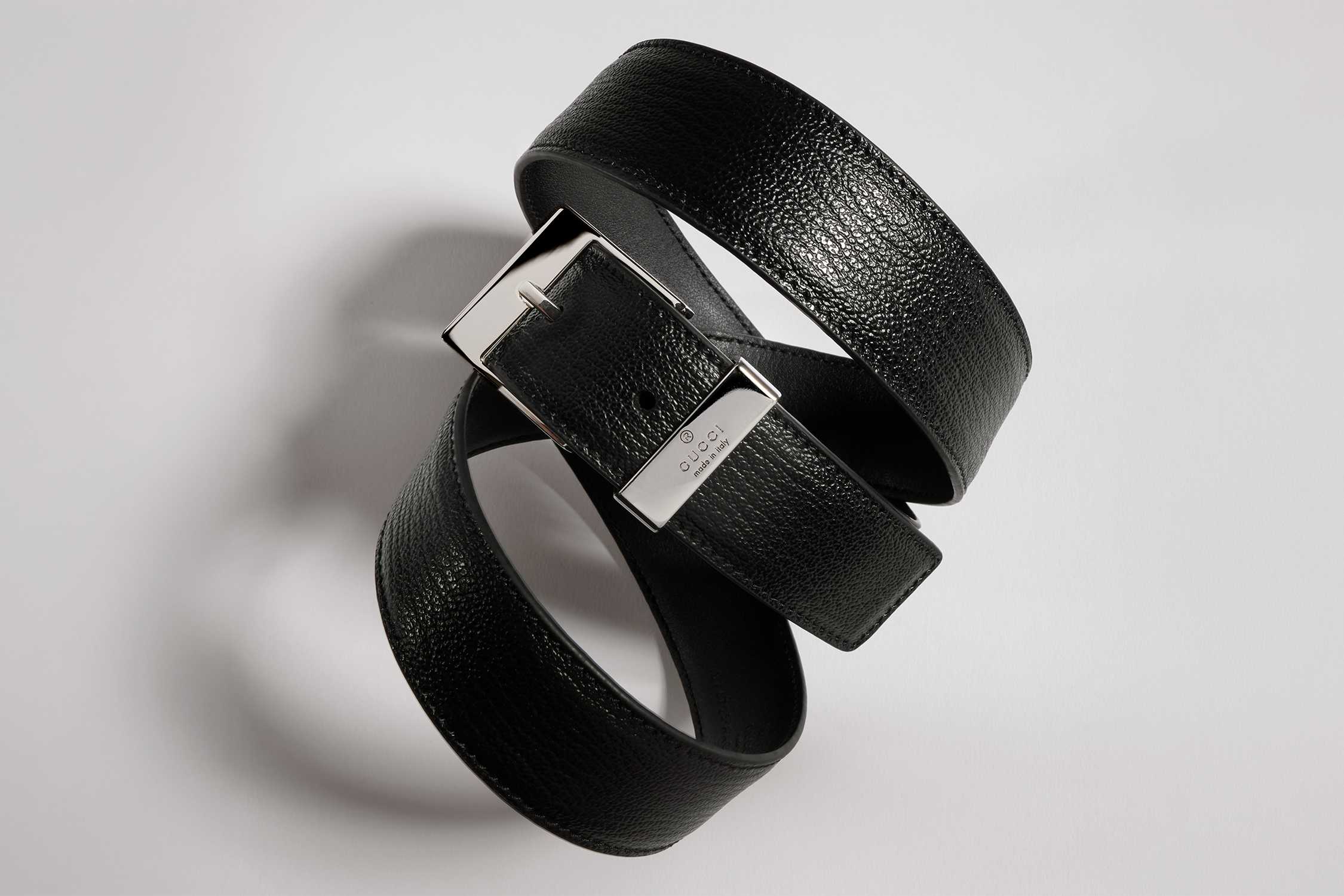 Black Gucci leather belt coiled