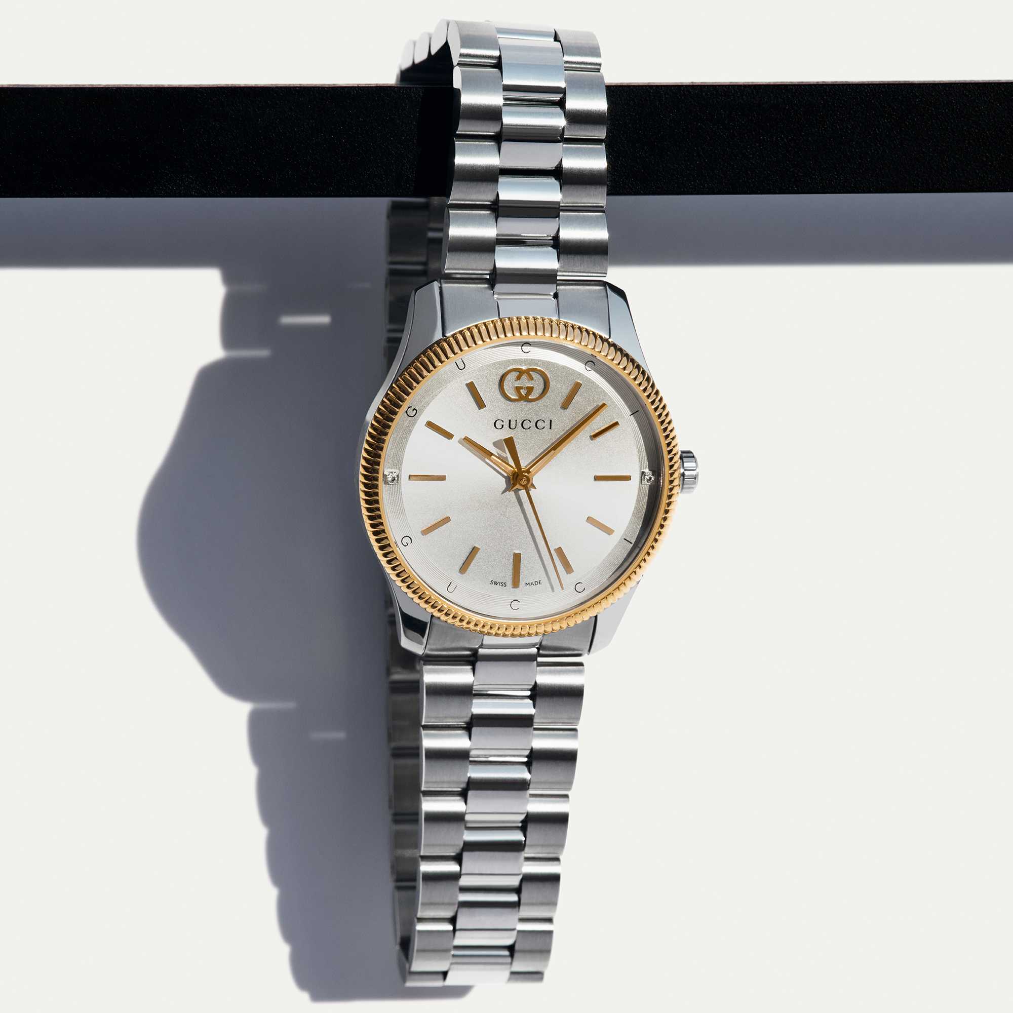 Silver Gucci watch gold bezel