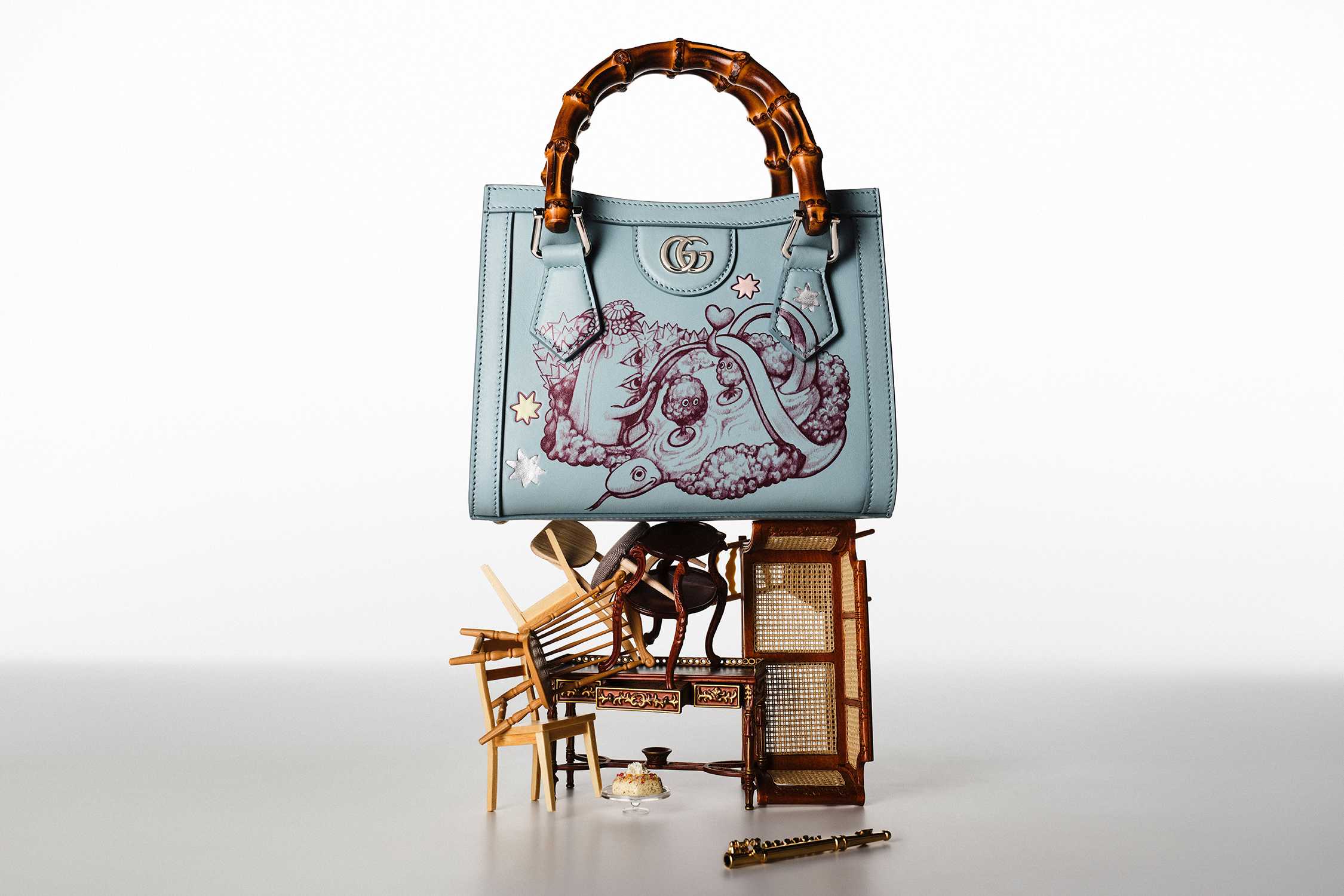 Blue Gucci bag with bamboo handles.