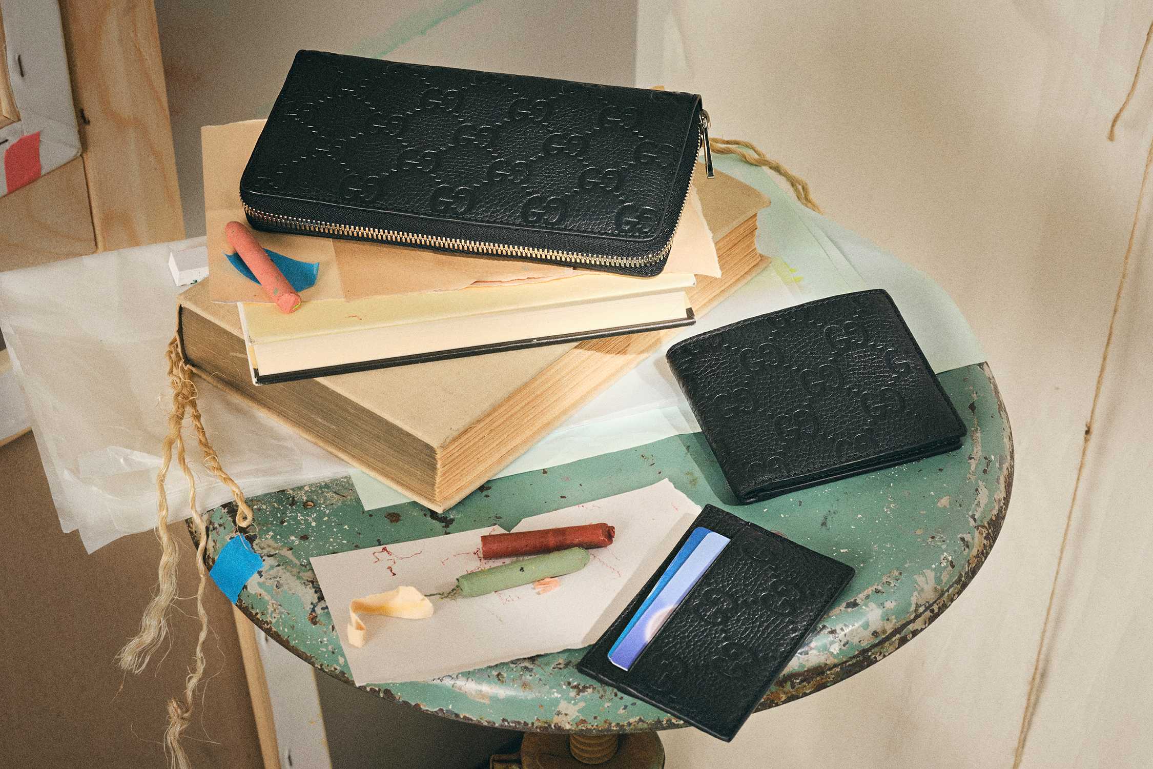 Black Gucci leather accessories displayed.