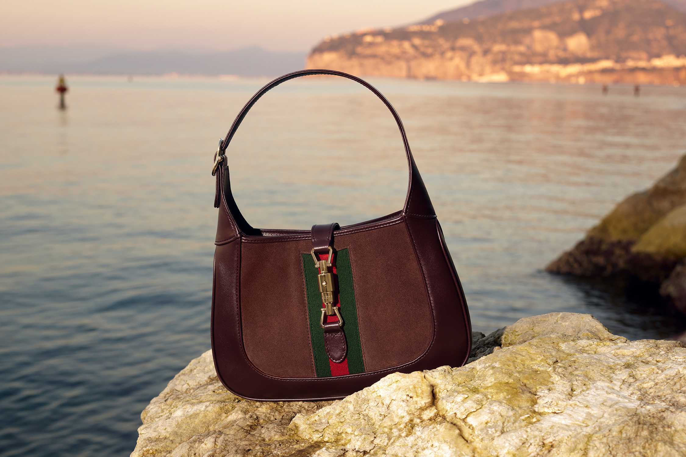 Brown Gucci handbag seaside sunset