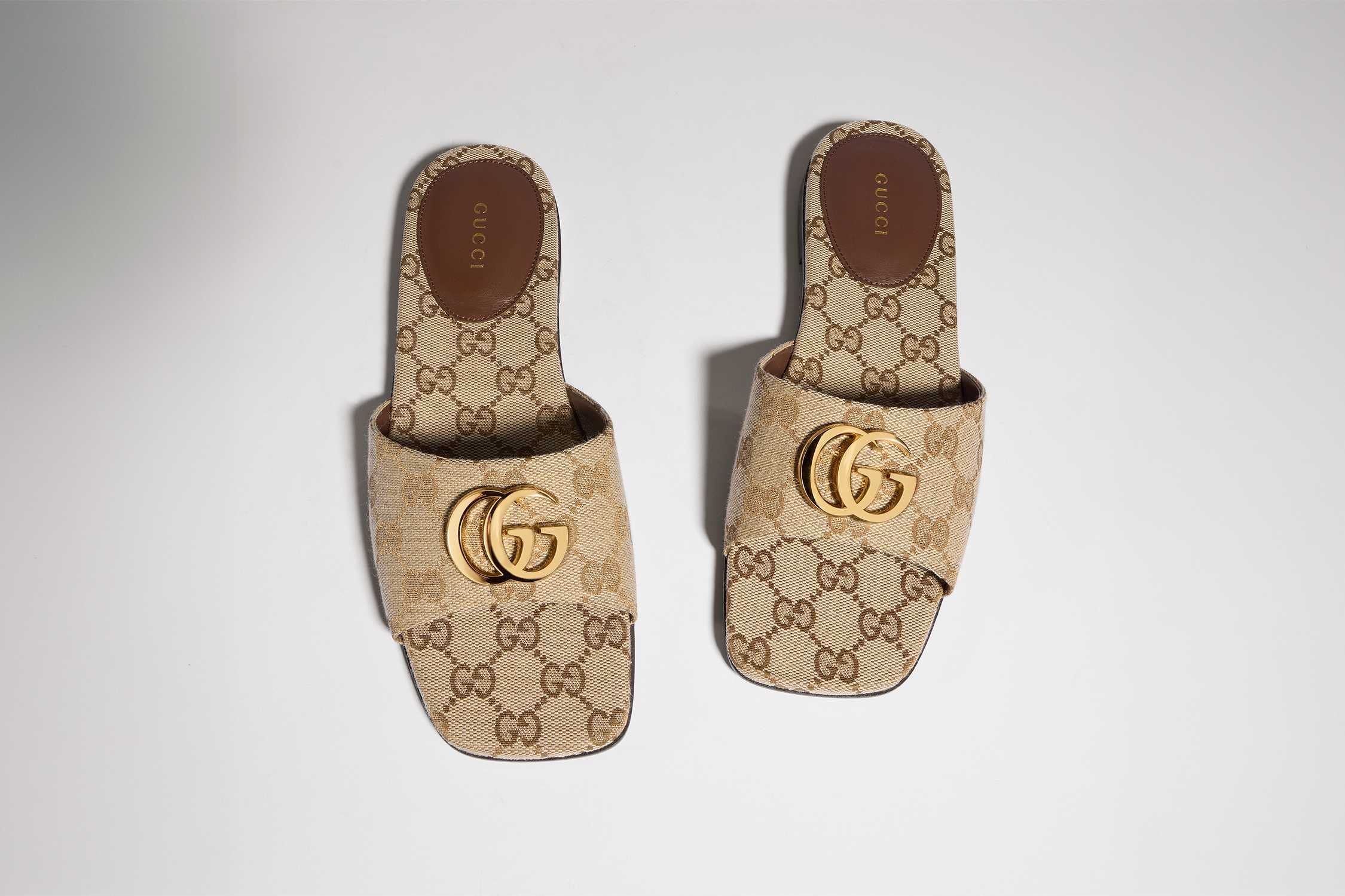 Beige Gucci monogram slide sandals