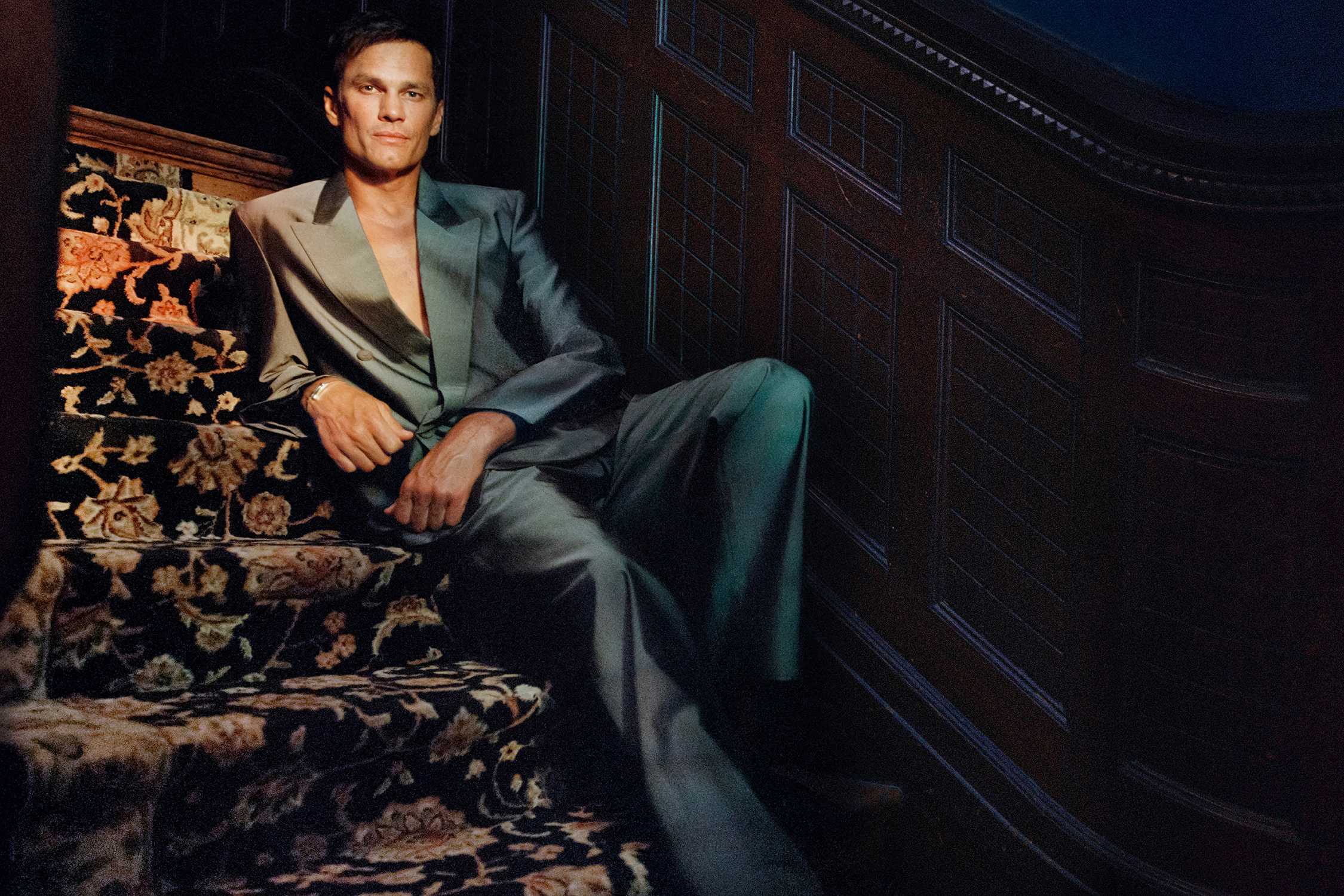 Man wearing grey-green Gucci suit.