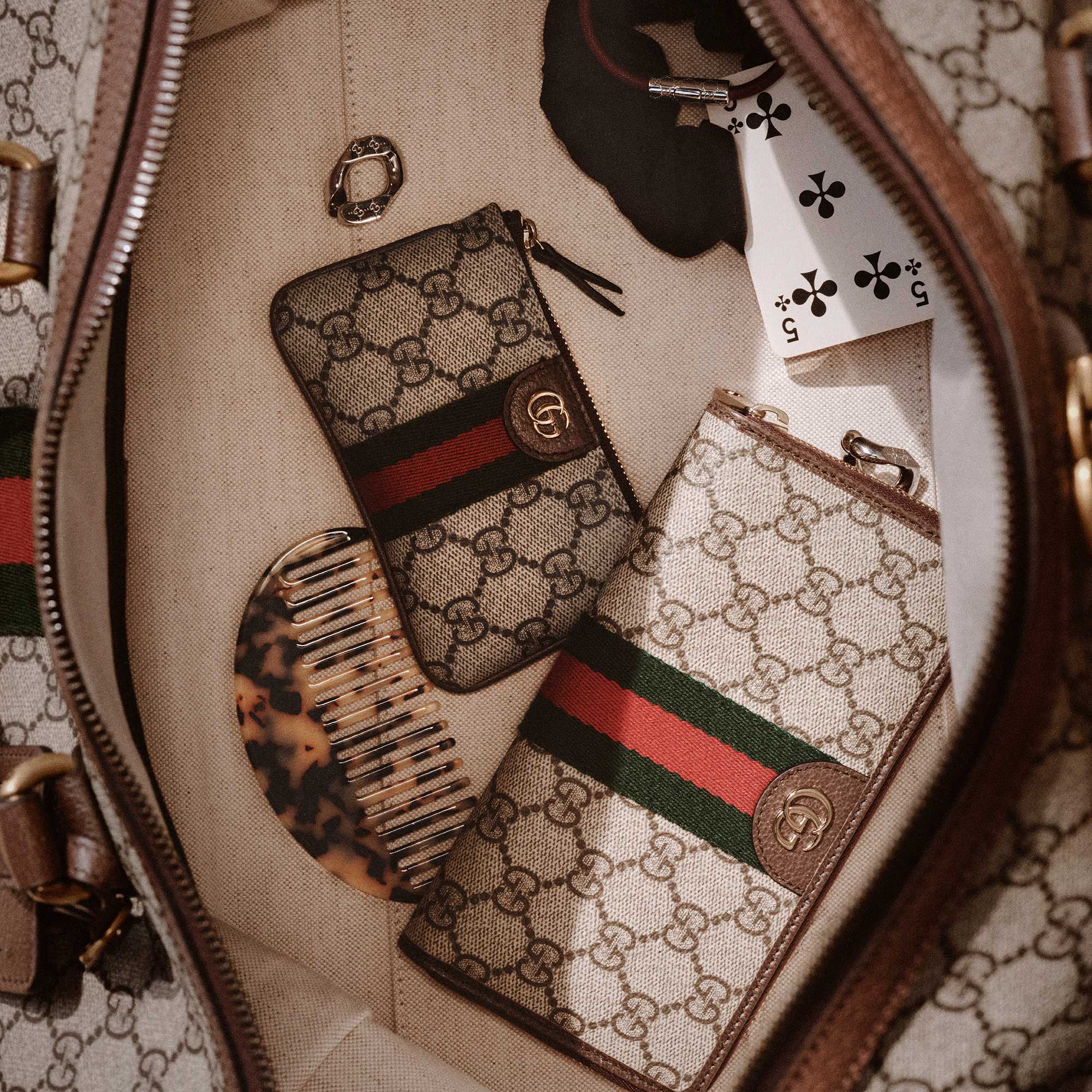 Gucci monogram wallets with red-green stripes.