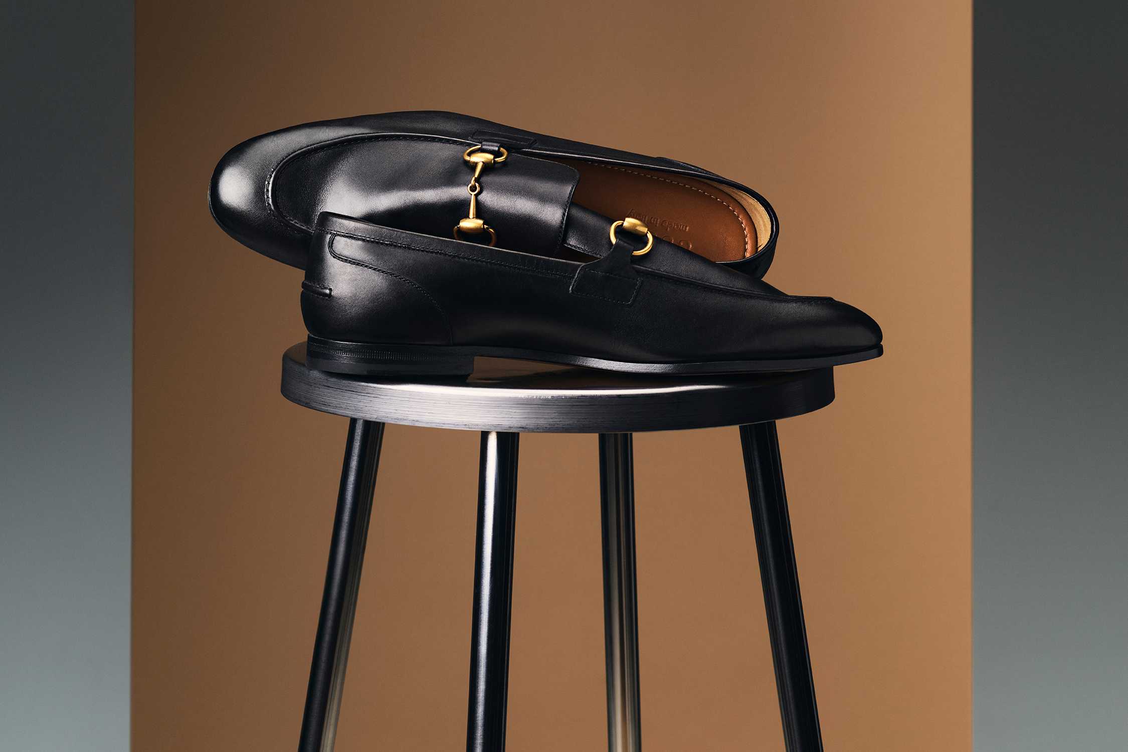 Black Gucci loafers with gold hardware.