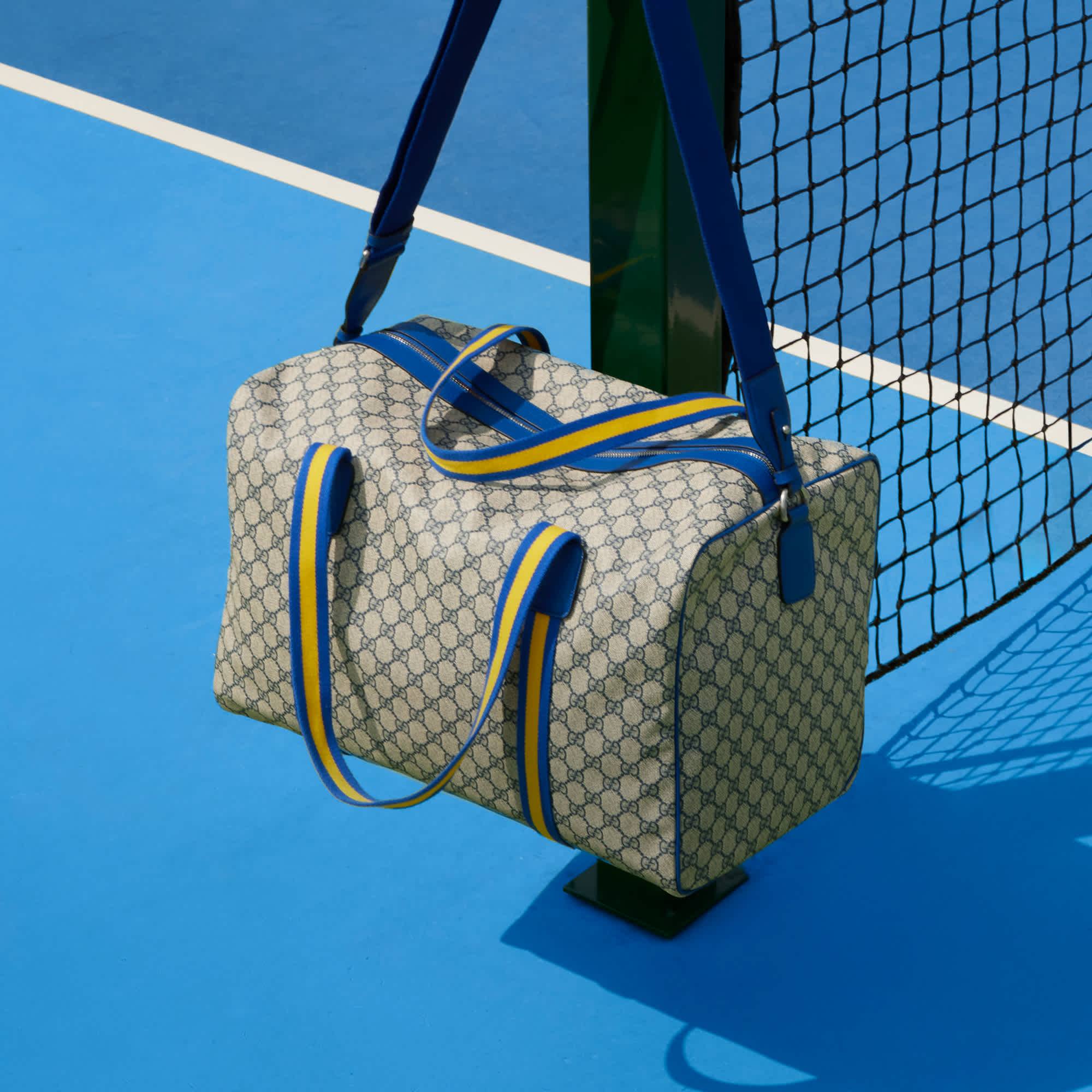 Gucci bag on blue court