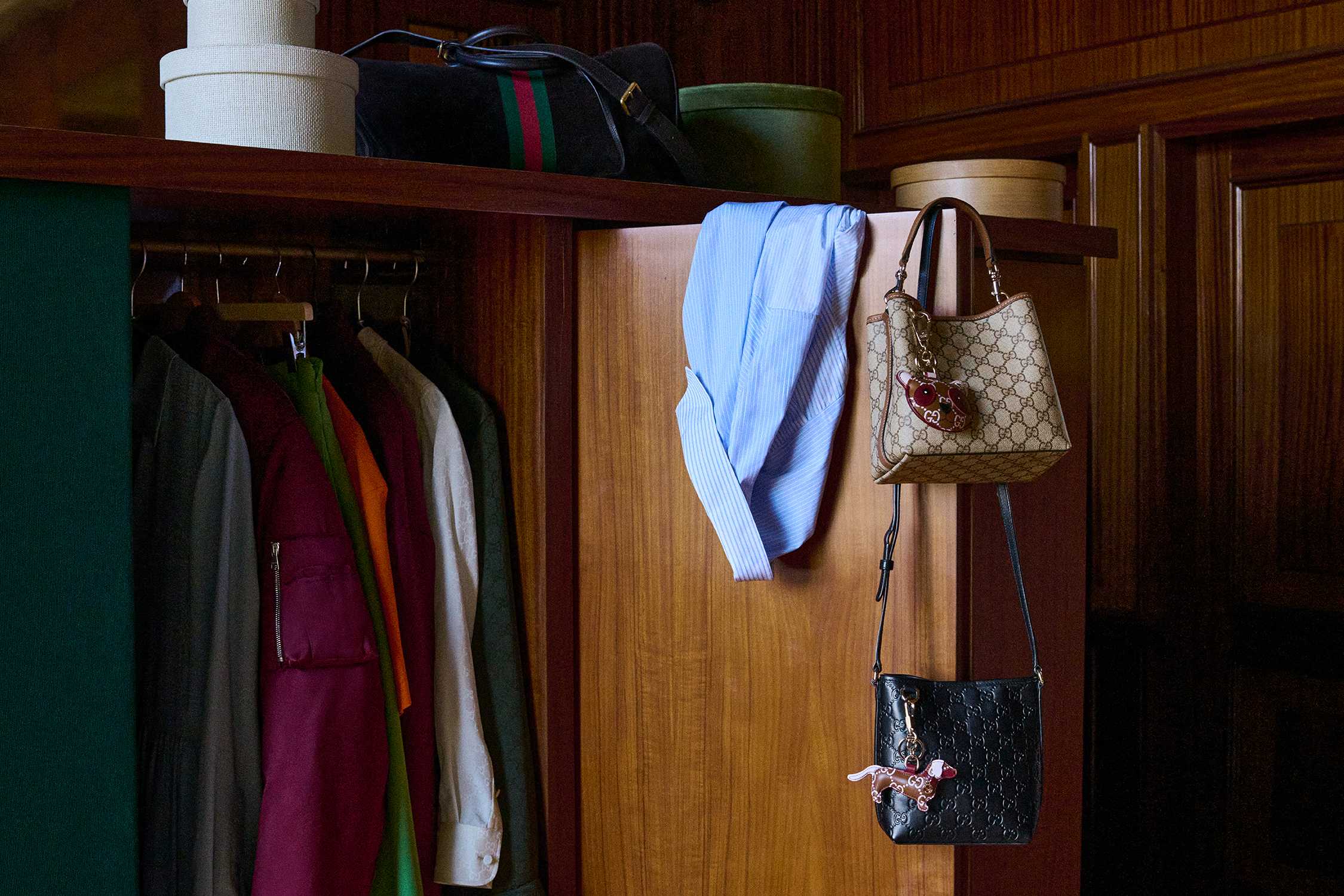 Gucci bags in wooden wardrobe