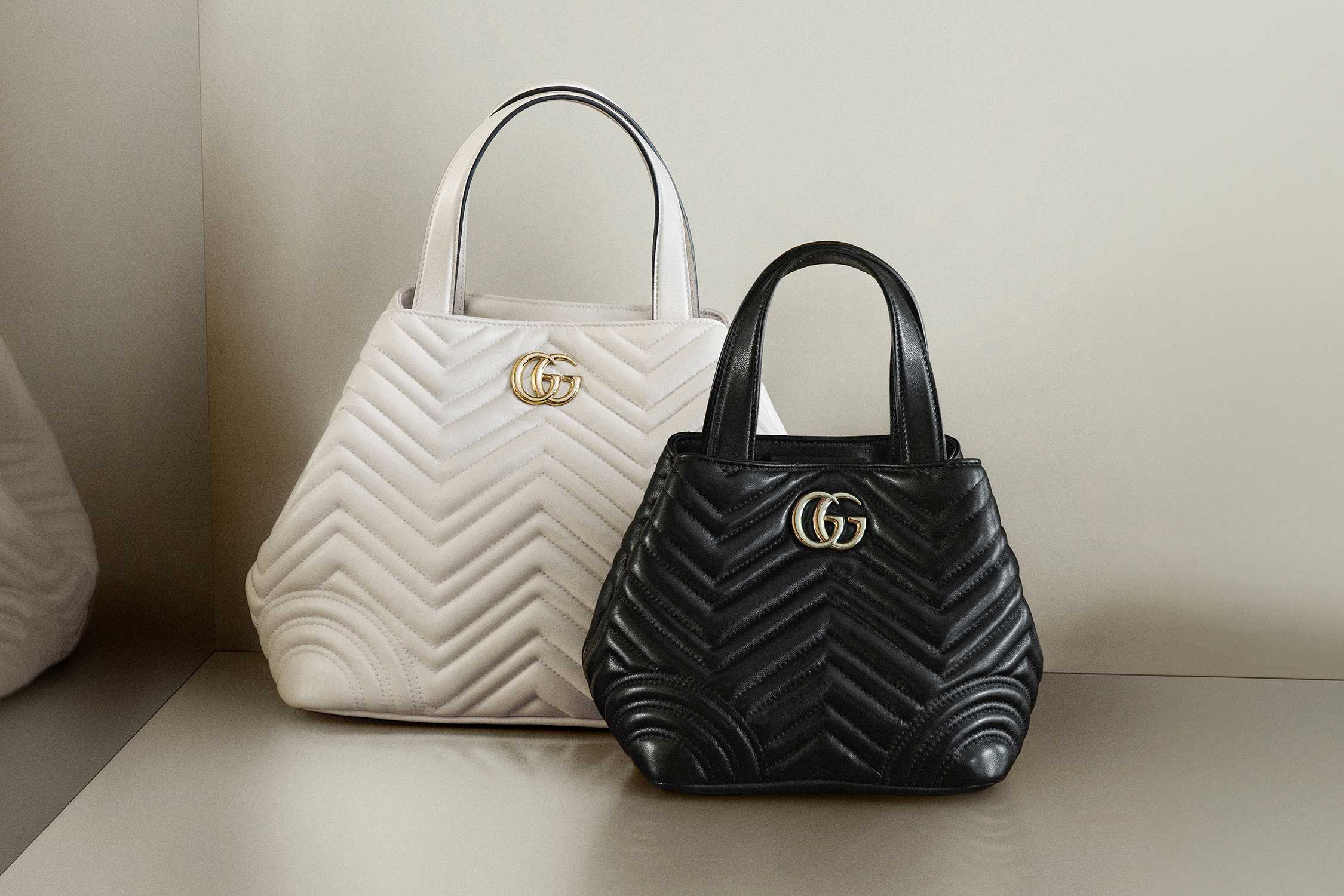 White and black Gucci handbags.