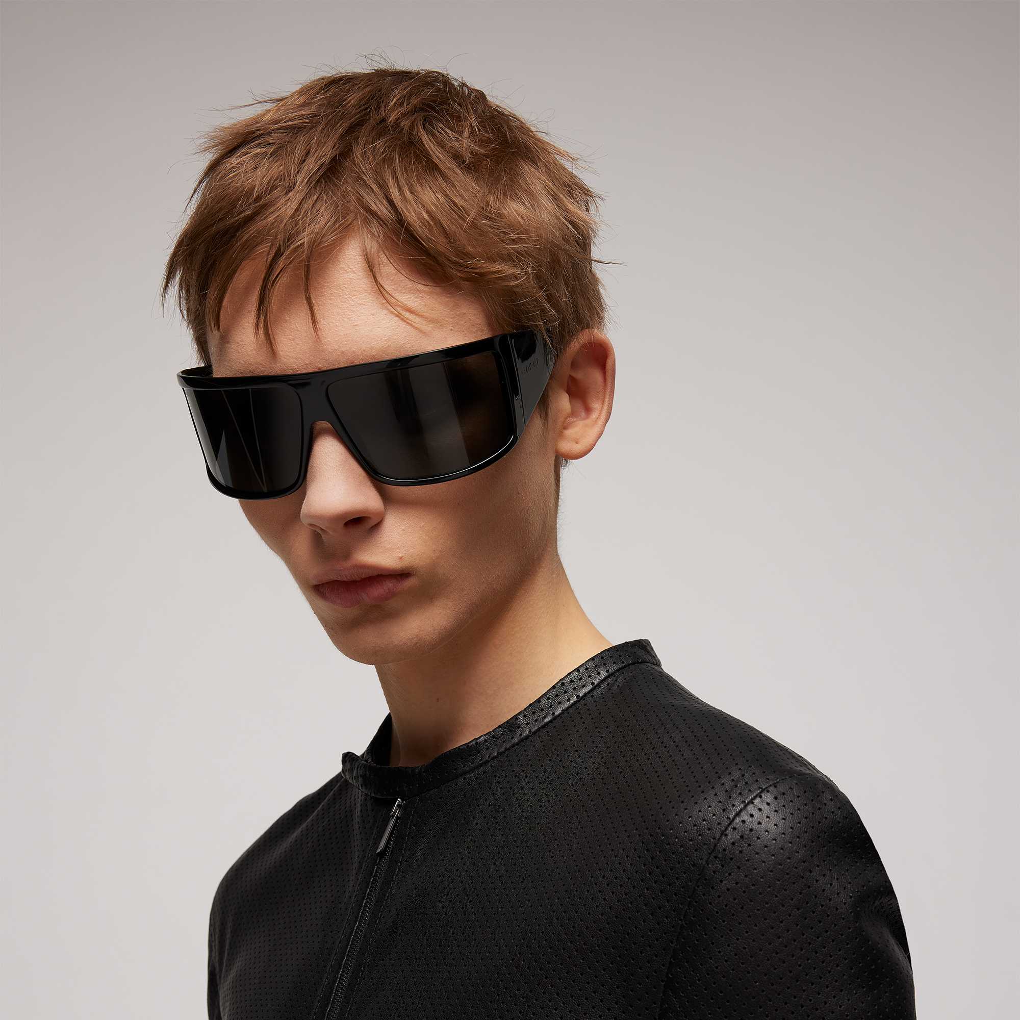 Model wearing black frame Gucci sunglasses