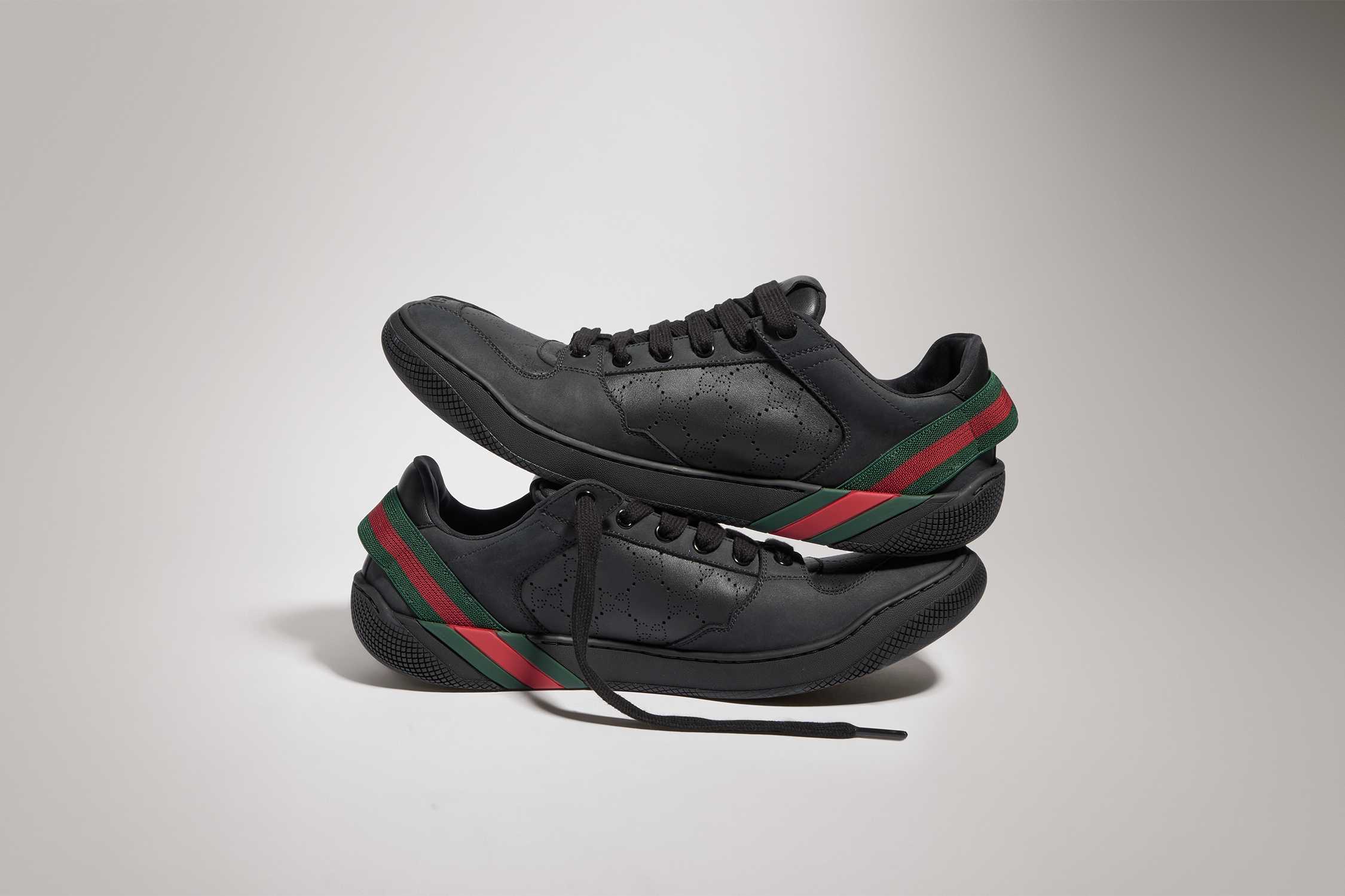 Black Gucci sneakers, red-green stripe.