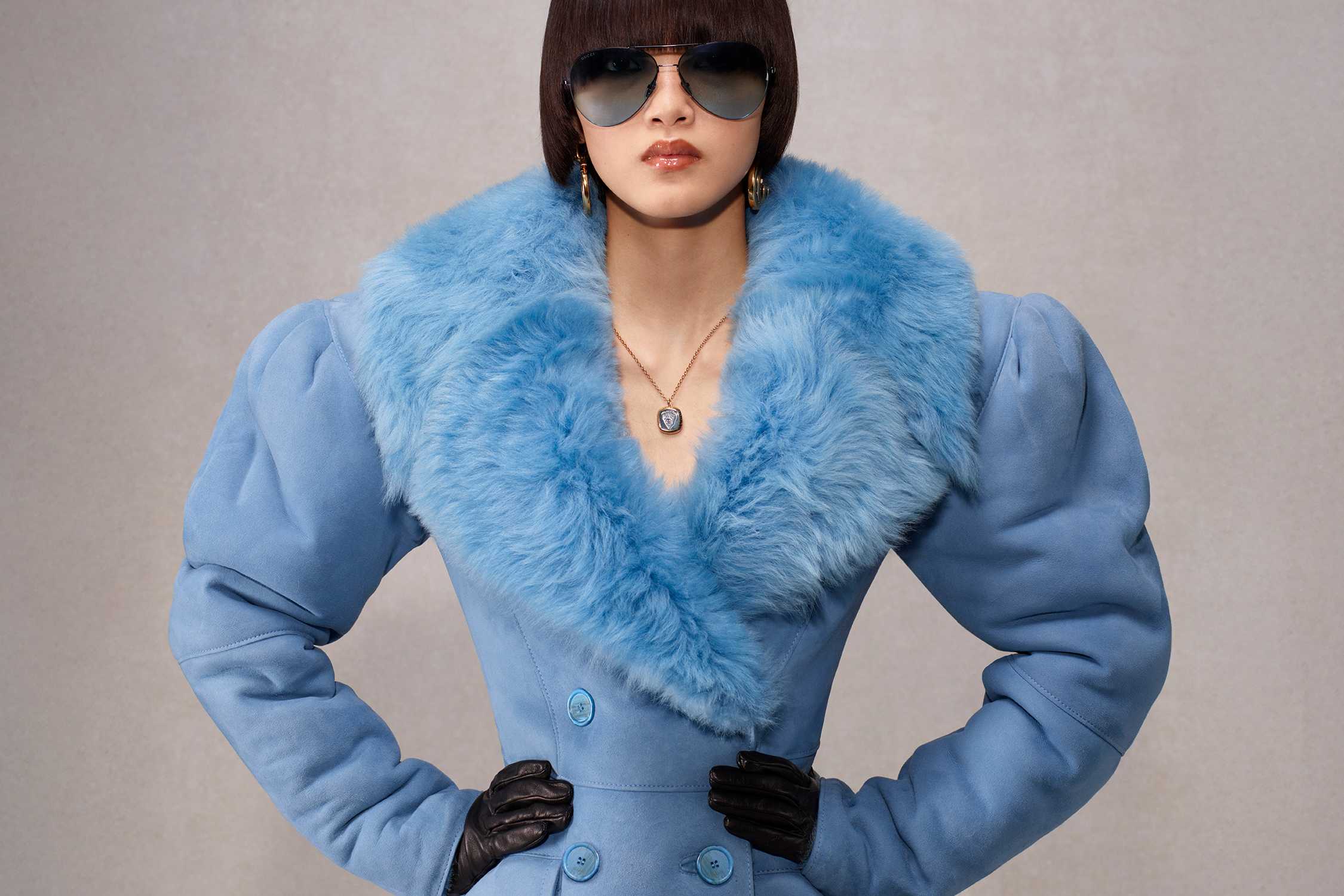 Blue coat with leather gloves