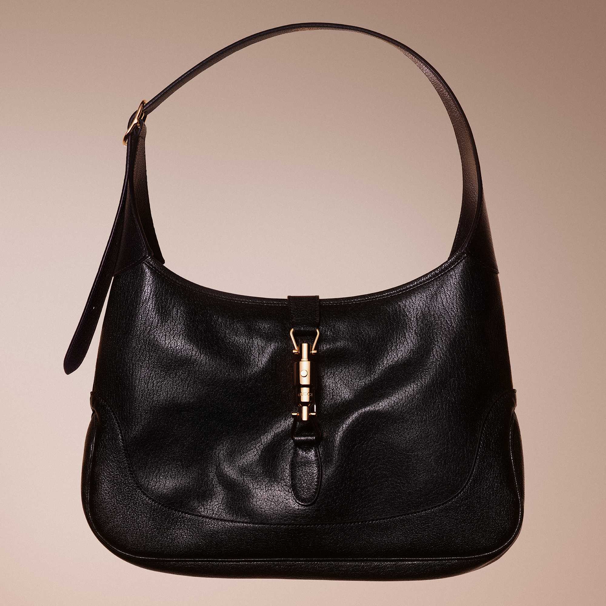 Green Gucci outfit, black bag.