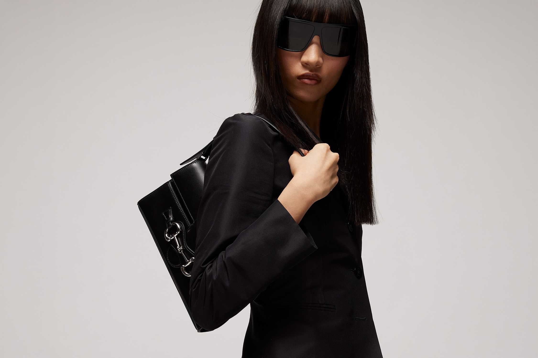 Black Gucci sunglasses and bag