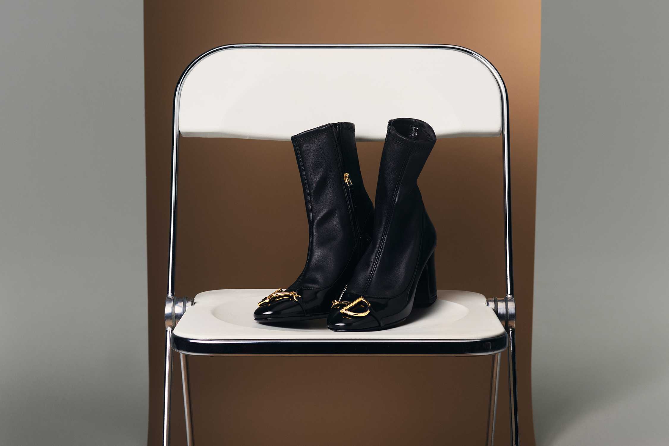 Black Gucci boots with gold hardware.
