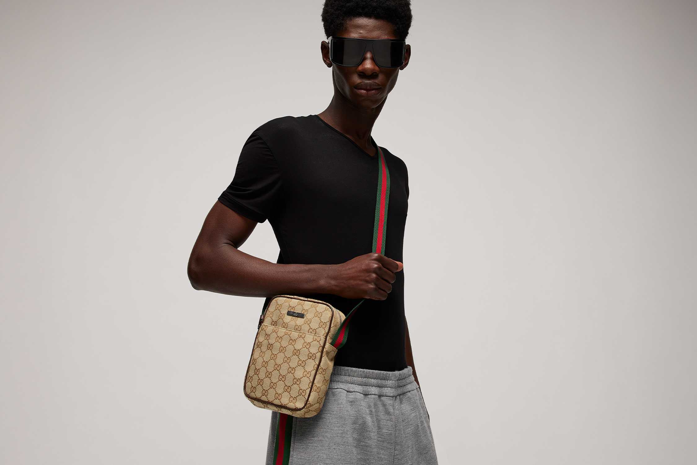 Beige Gucci crossbody bag, red-green strap.