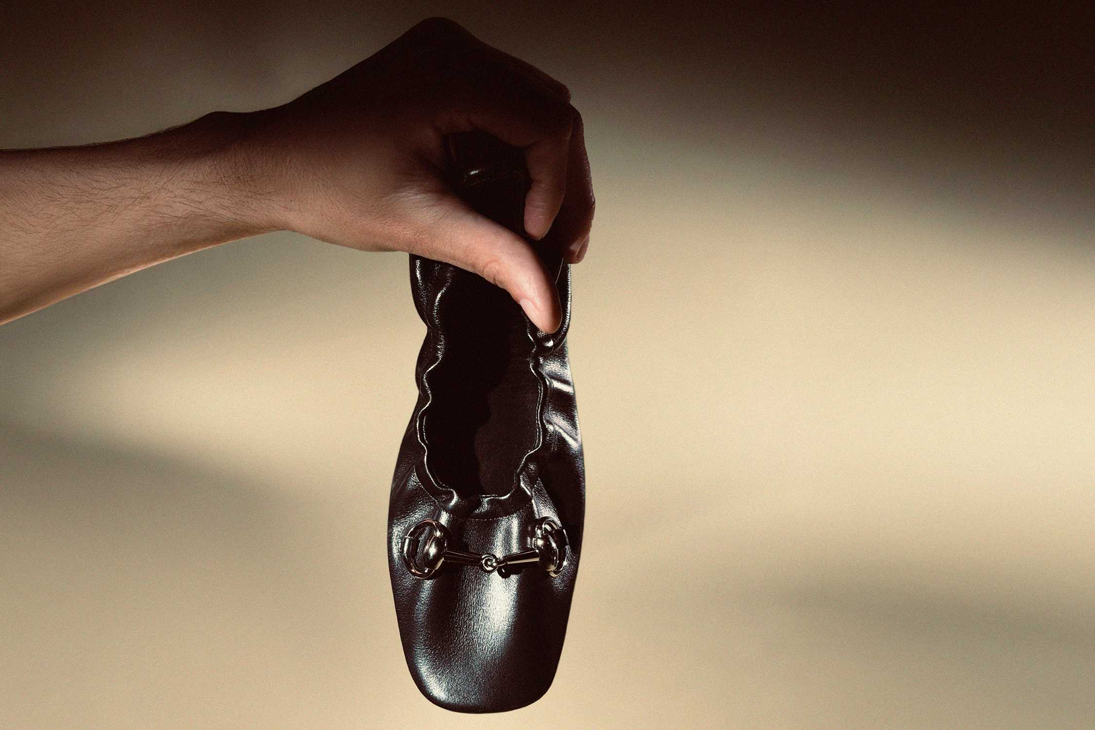 Black Gucci ballet flat held