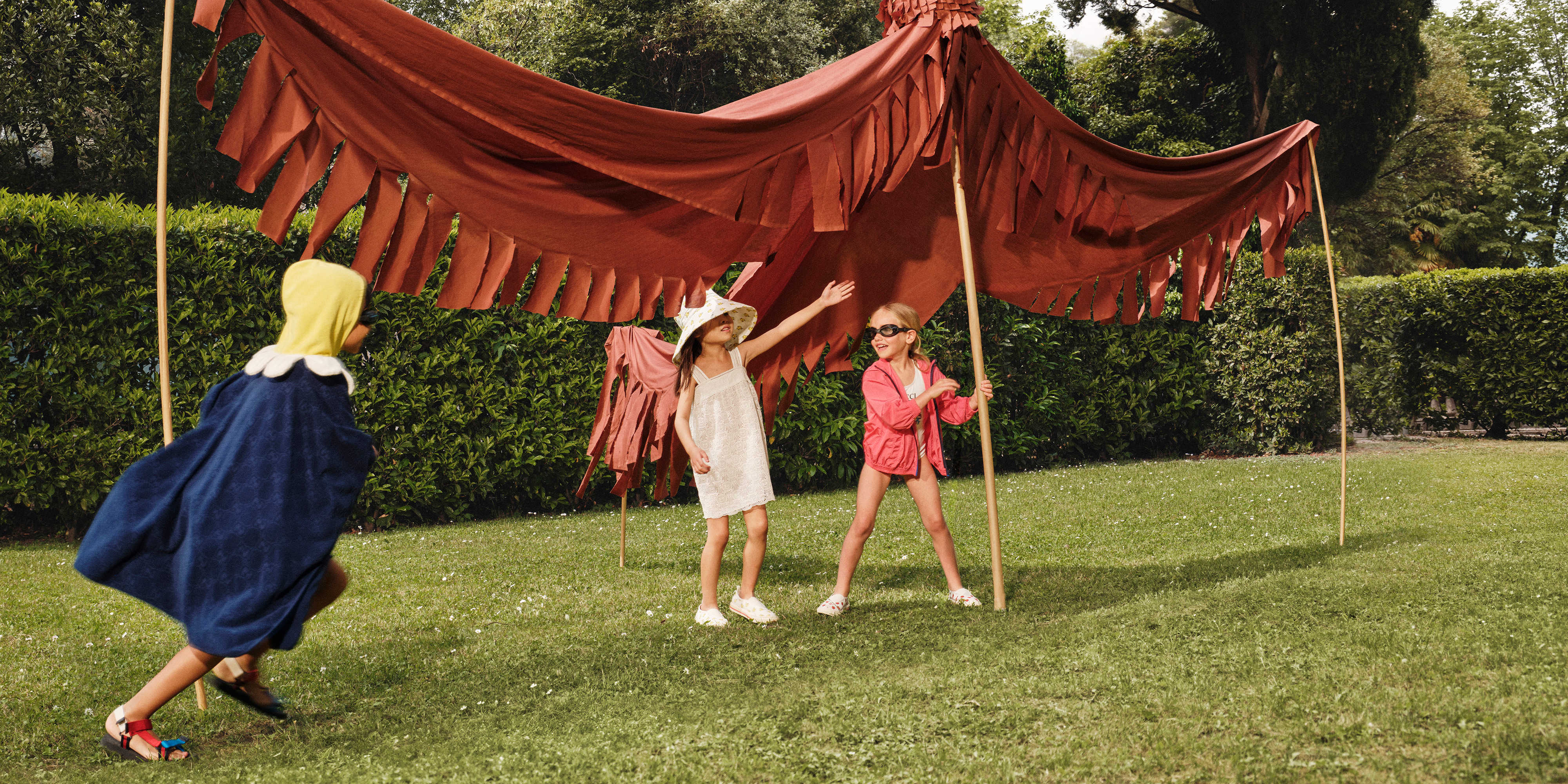 Children wearing Gucci playing outside