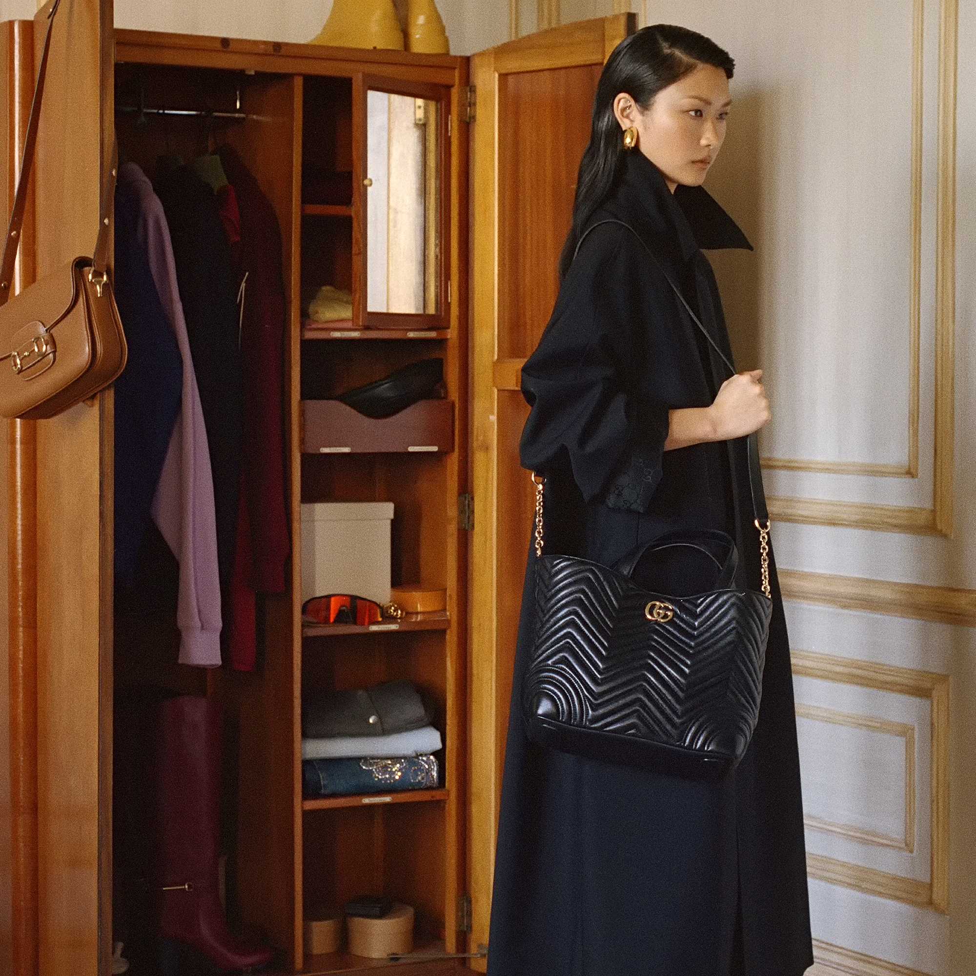 Black Gucci quilted handbag displayed.