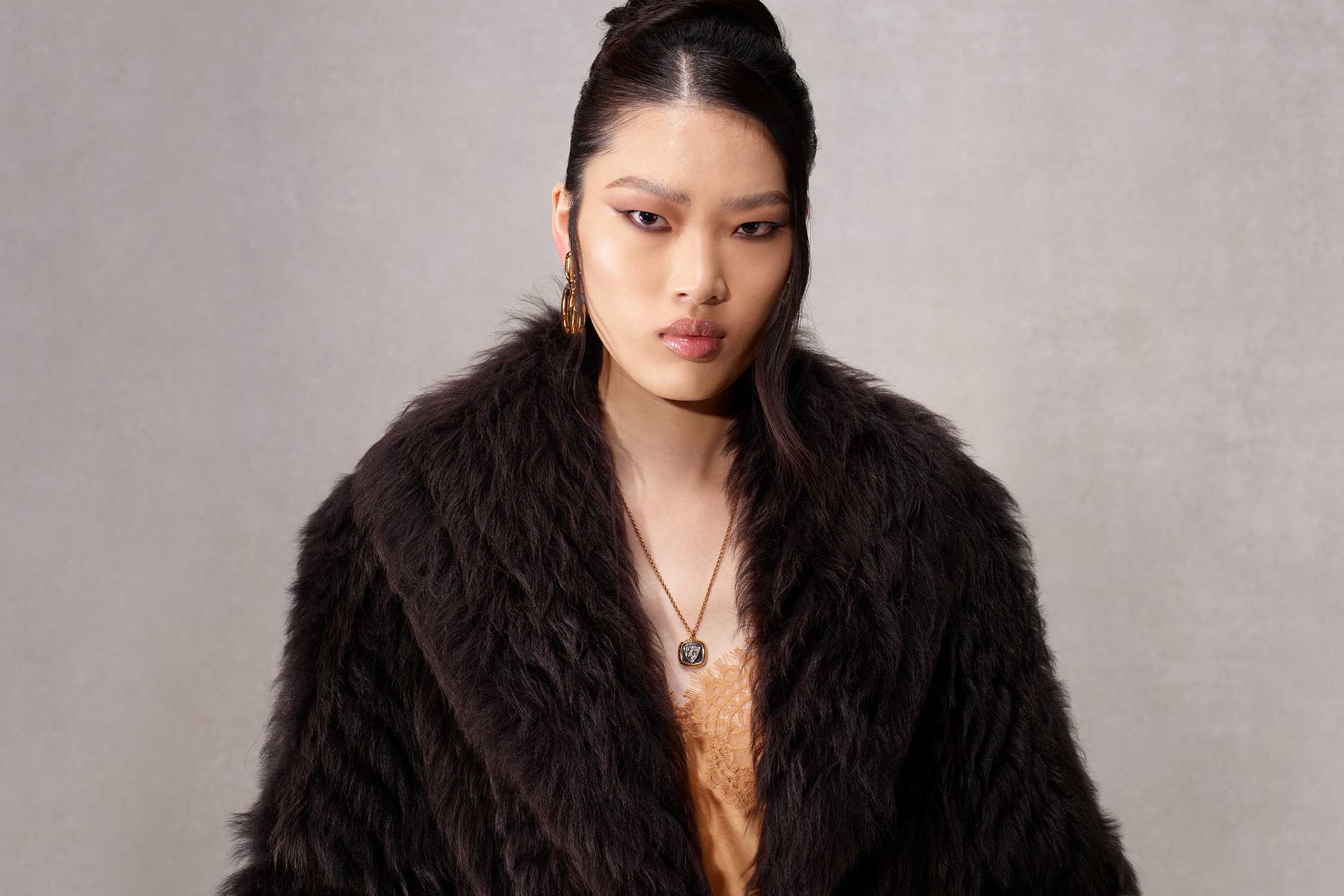 Black Gucci fur coat gold
