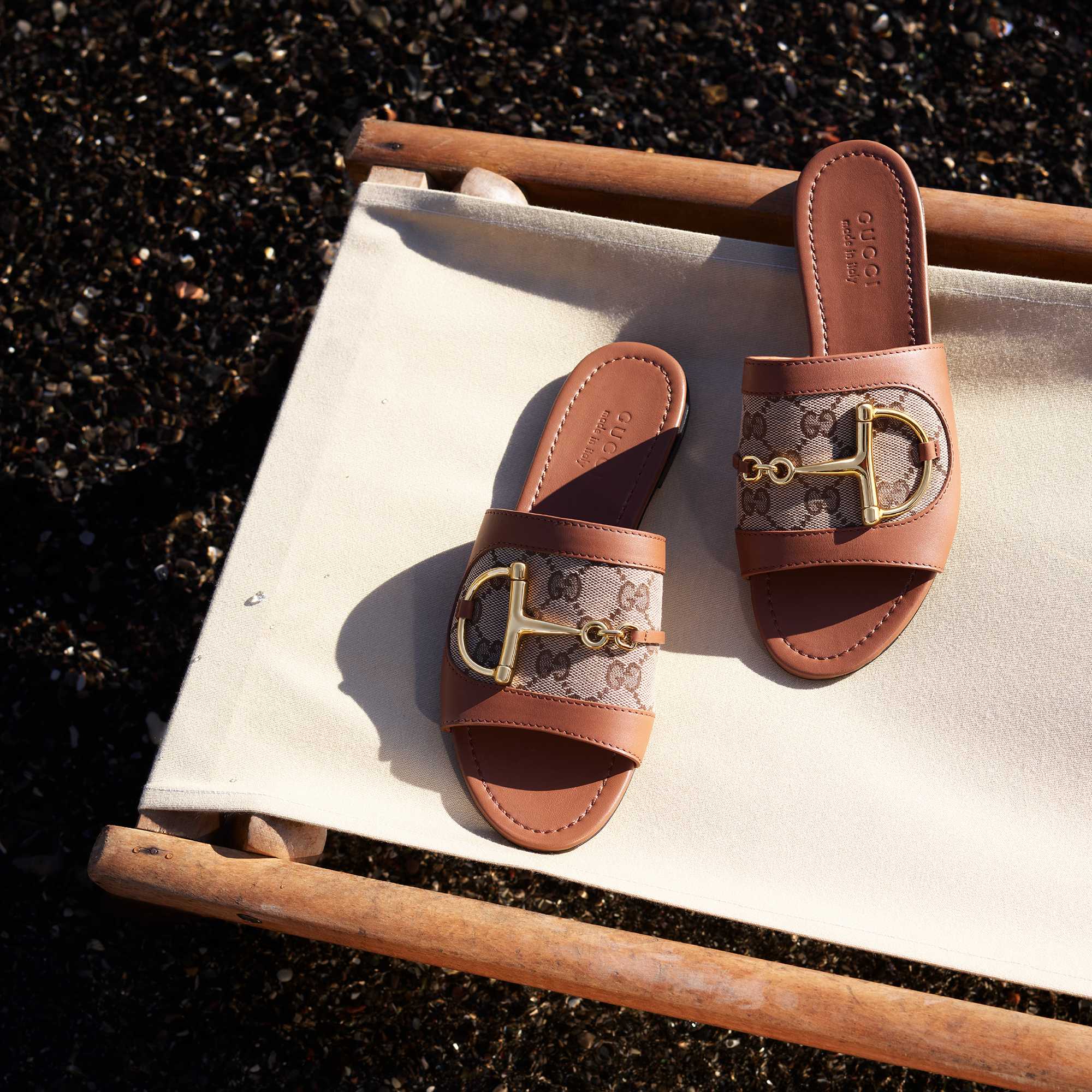 Brown Gucci sandals with gold hardware.