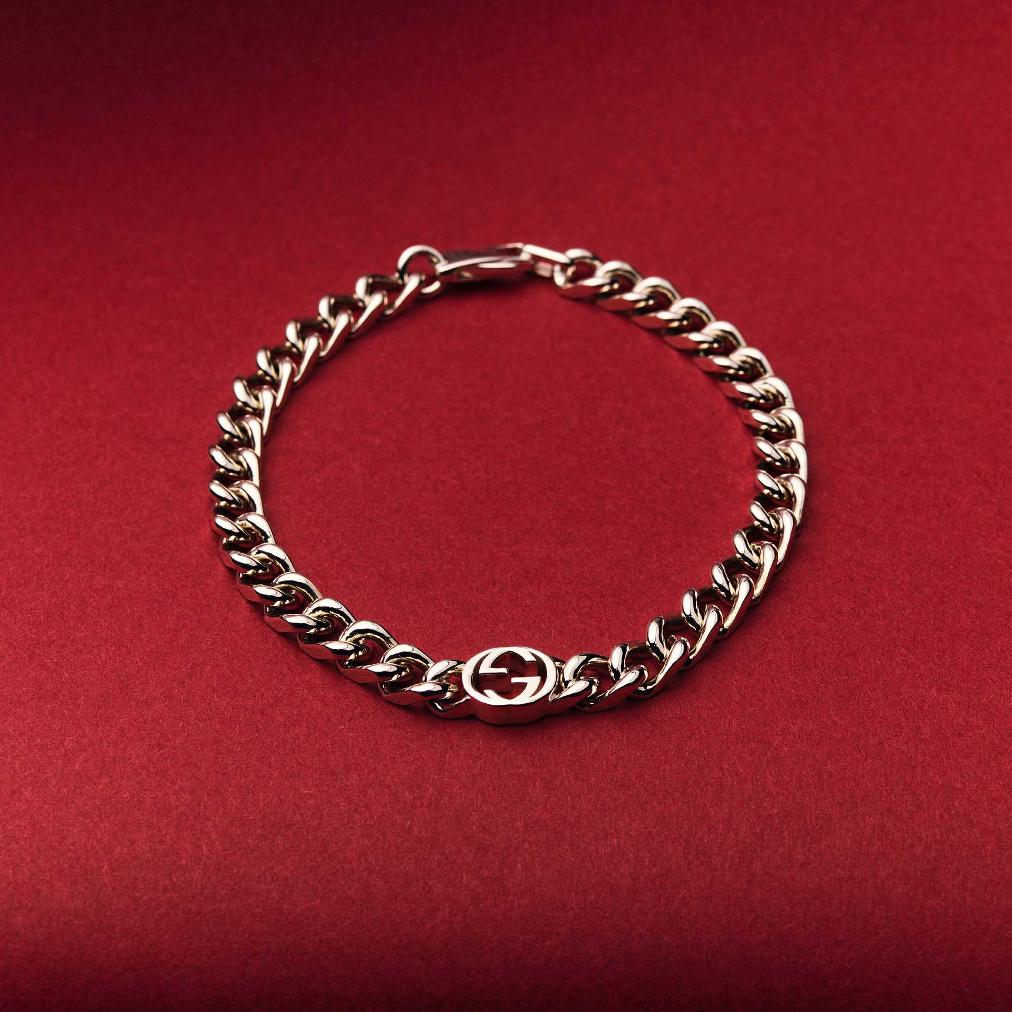 Silver Gucci bracelet on red