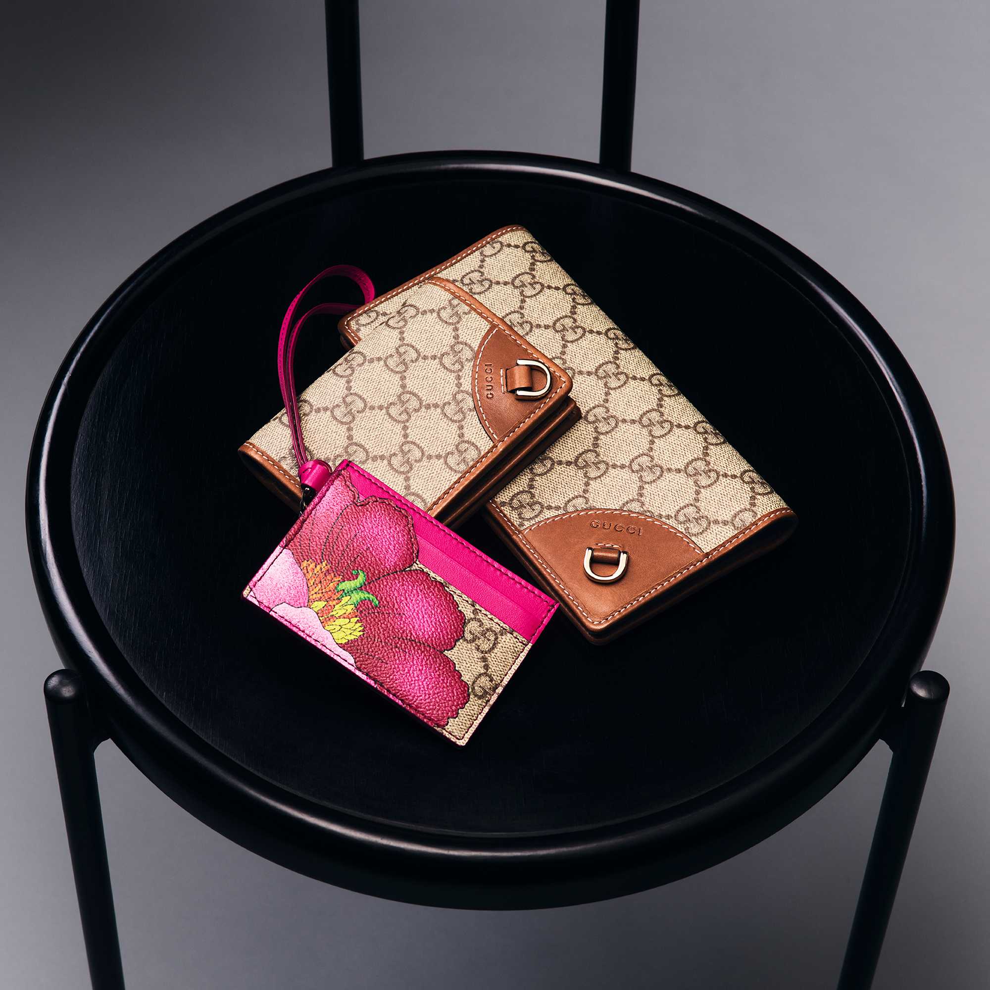 Gucci monogram wallets with red-green stripes.