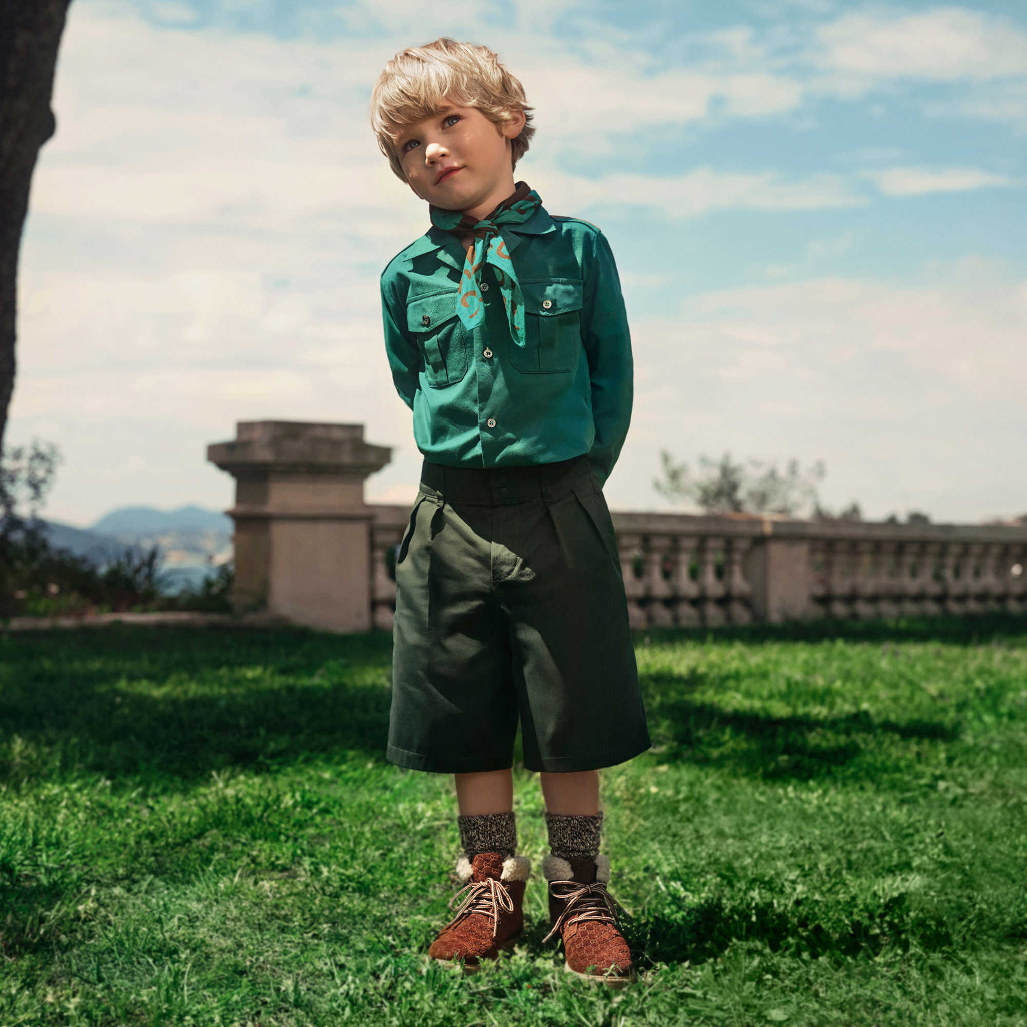 Green Gucci children's outfit outdoors