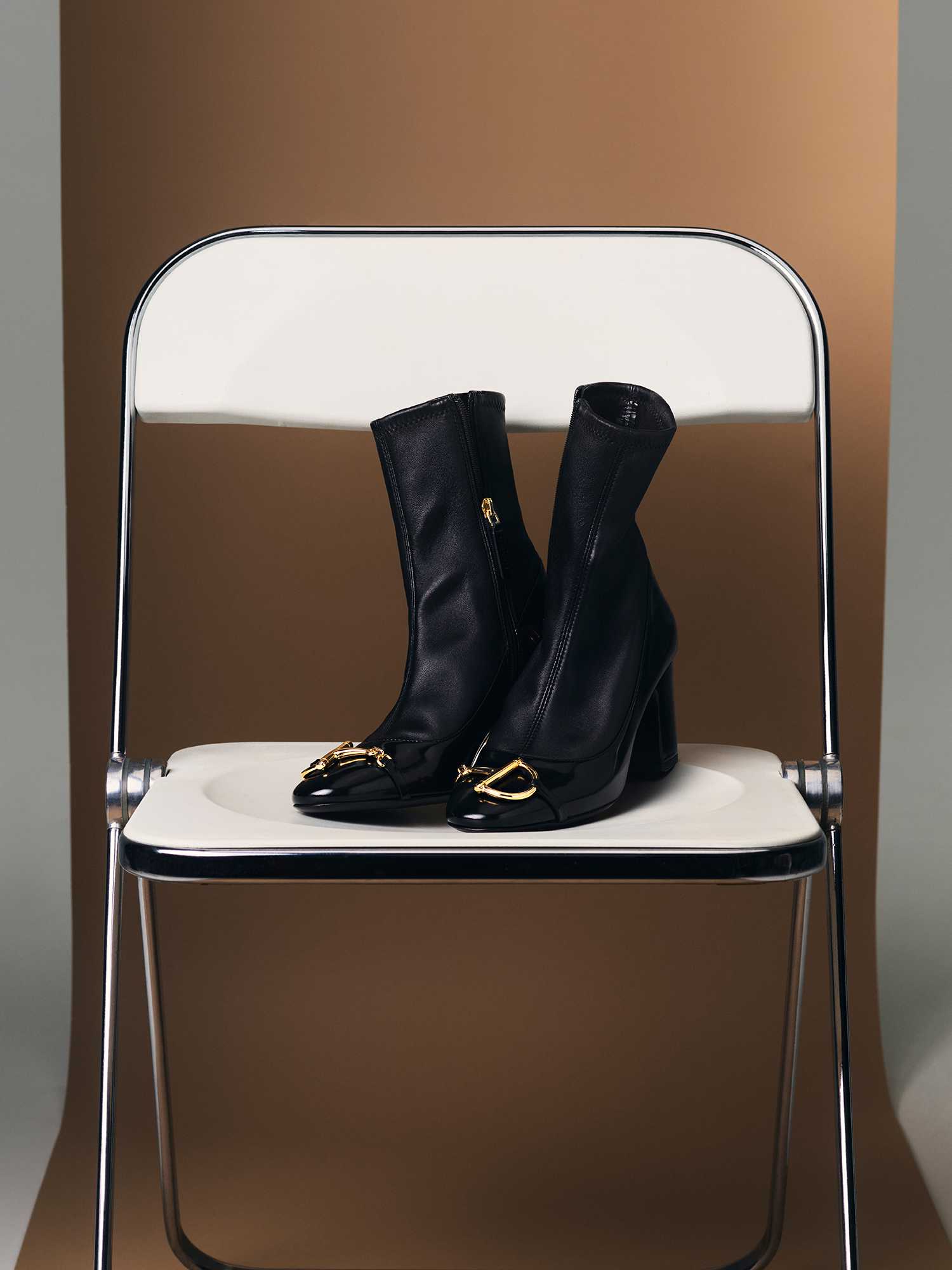 Black Gucci boots with gold hardware.