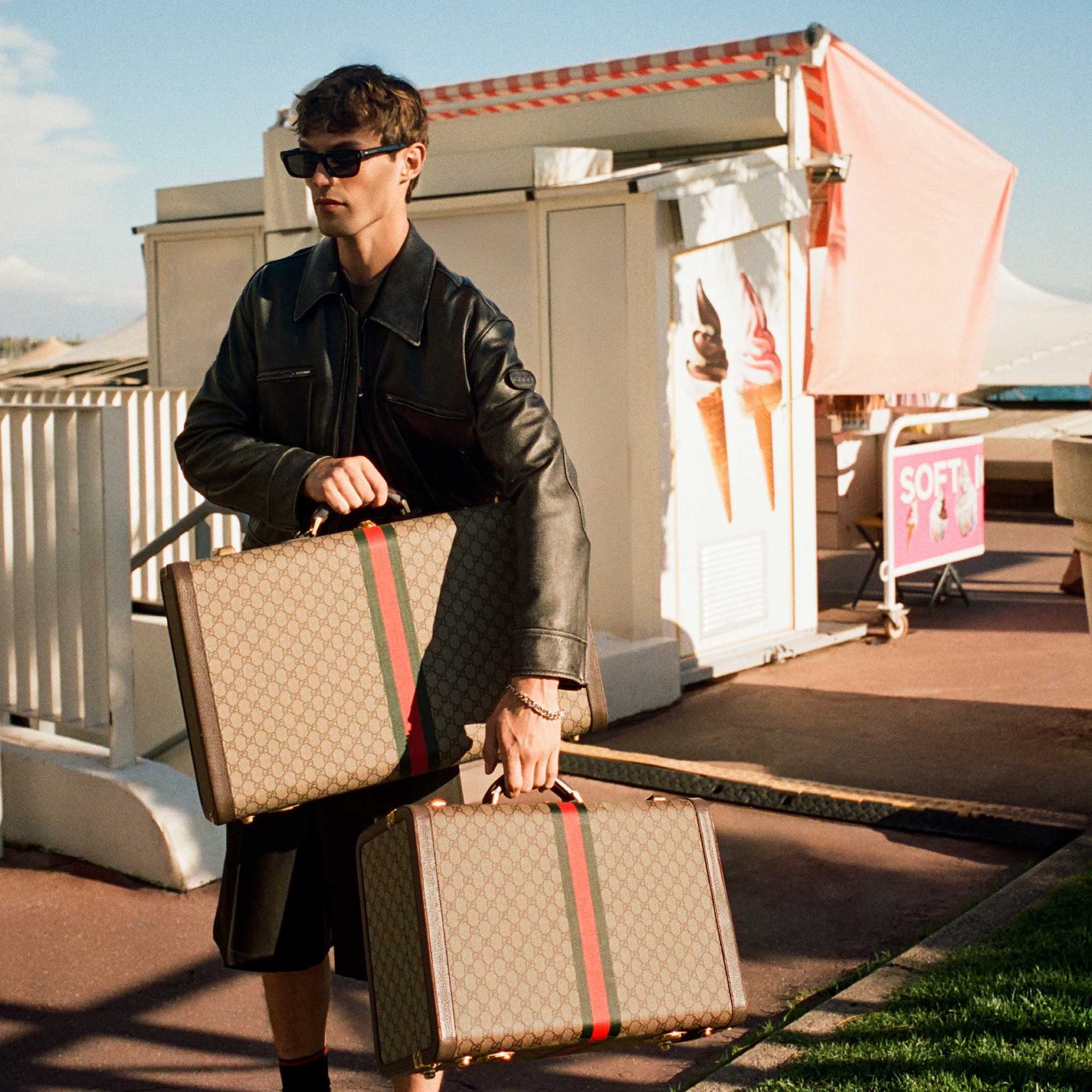 Beige Gucci luggage with red-green stripes