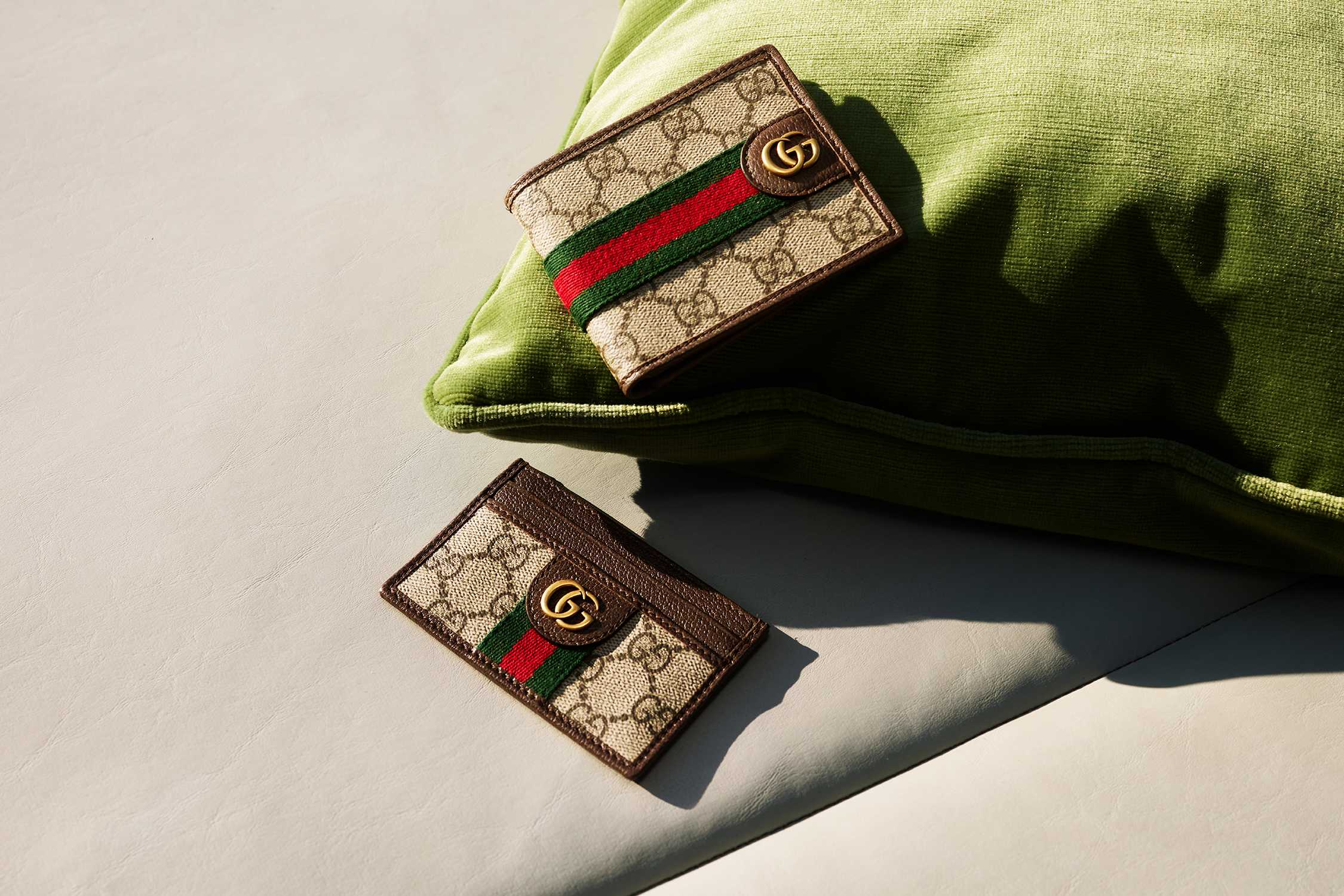Gucci accessories on green cushion