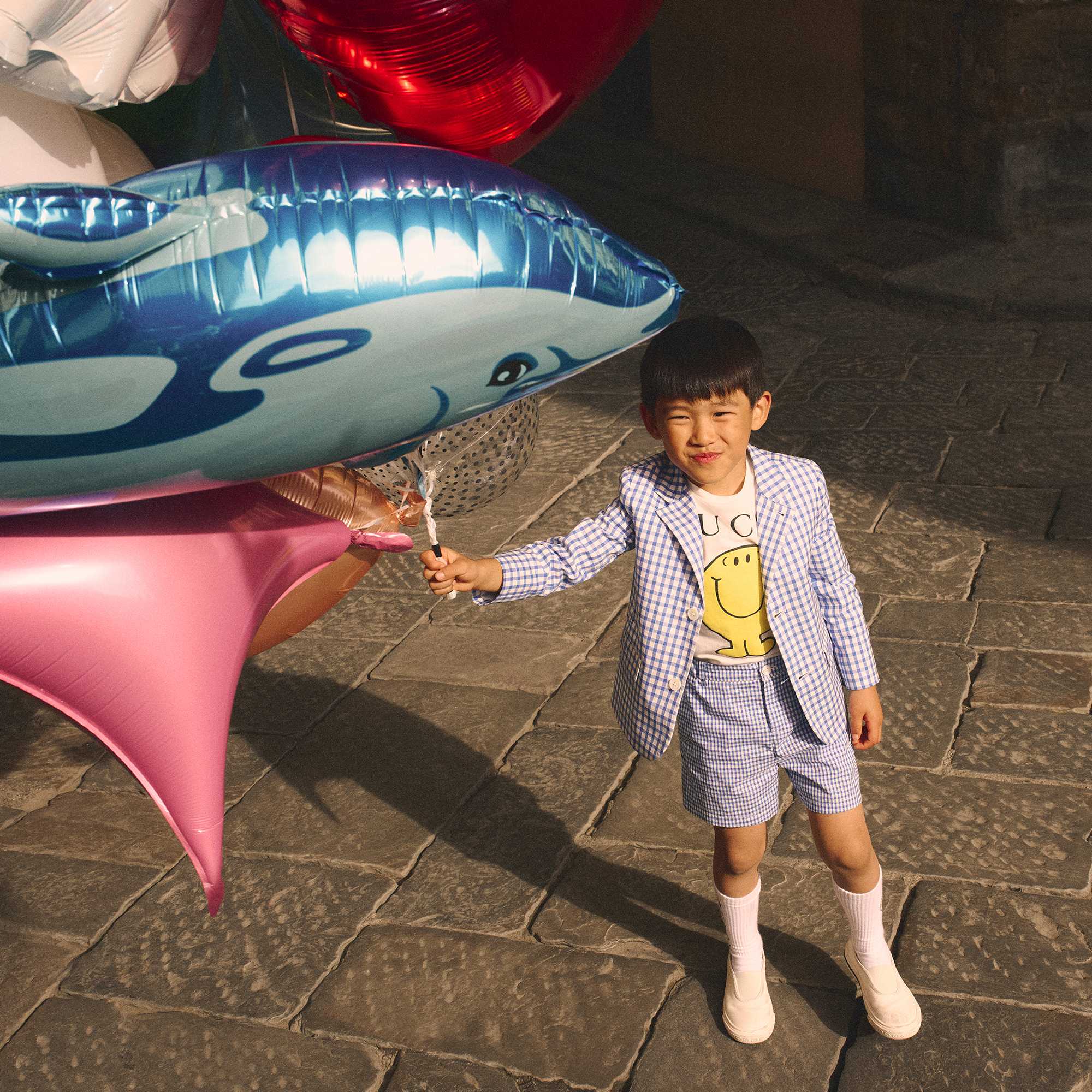 Green Gucci children's outfit outdoors