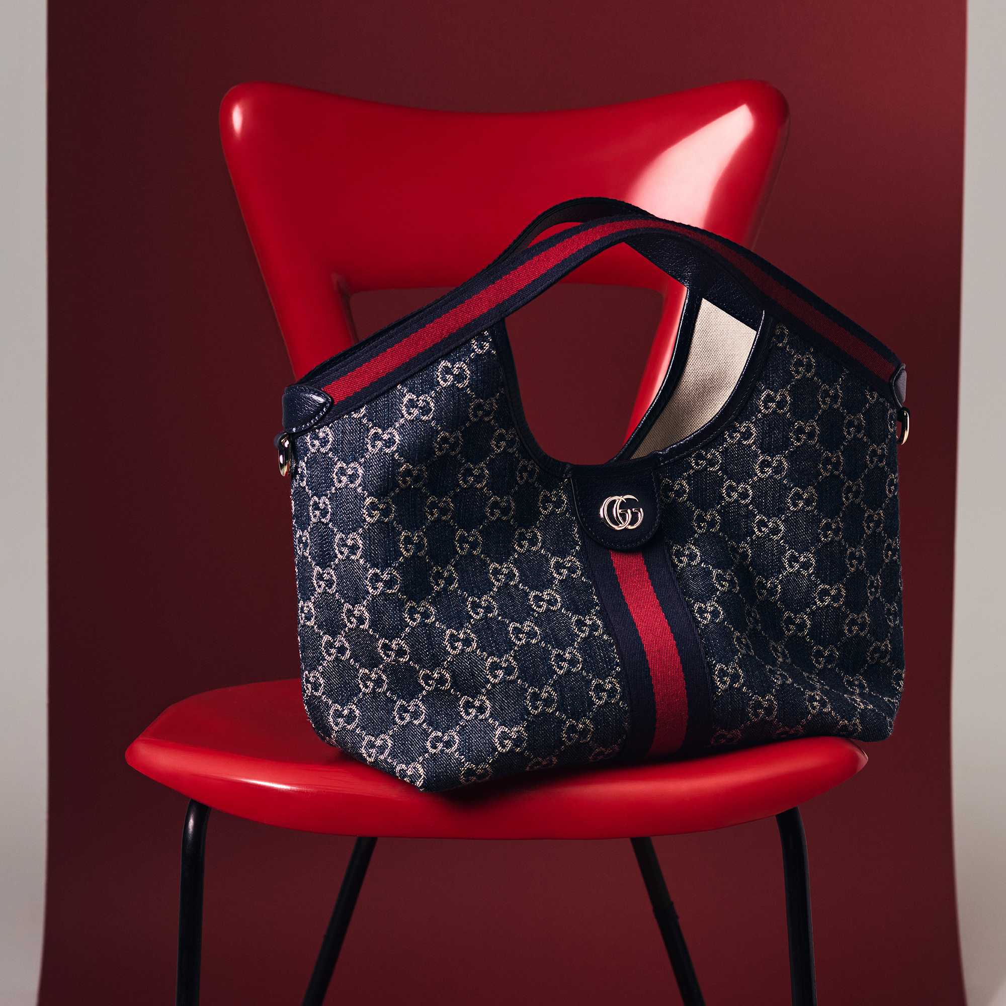Gucci monogram bag on red chair