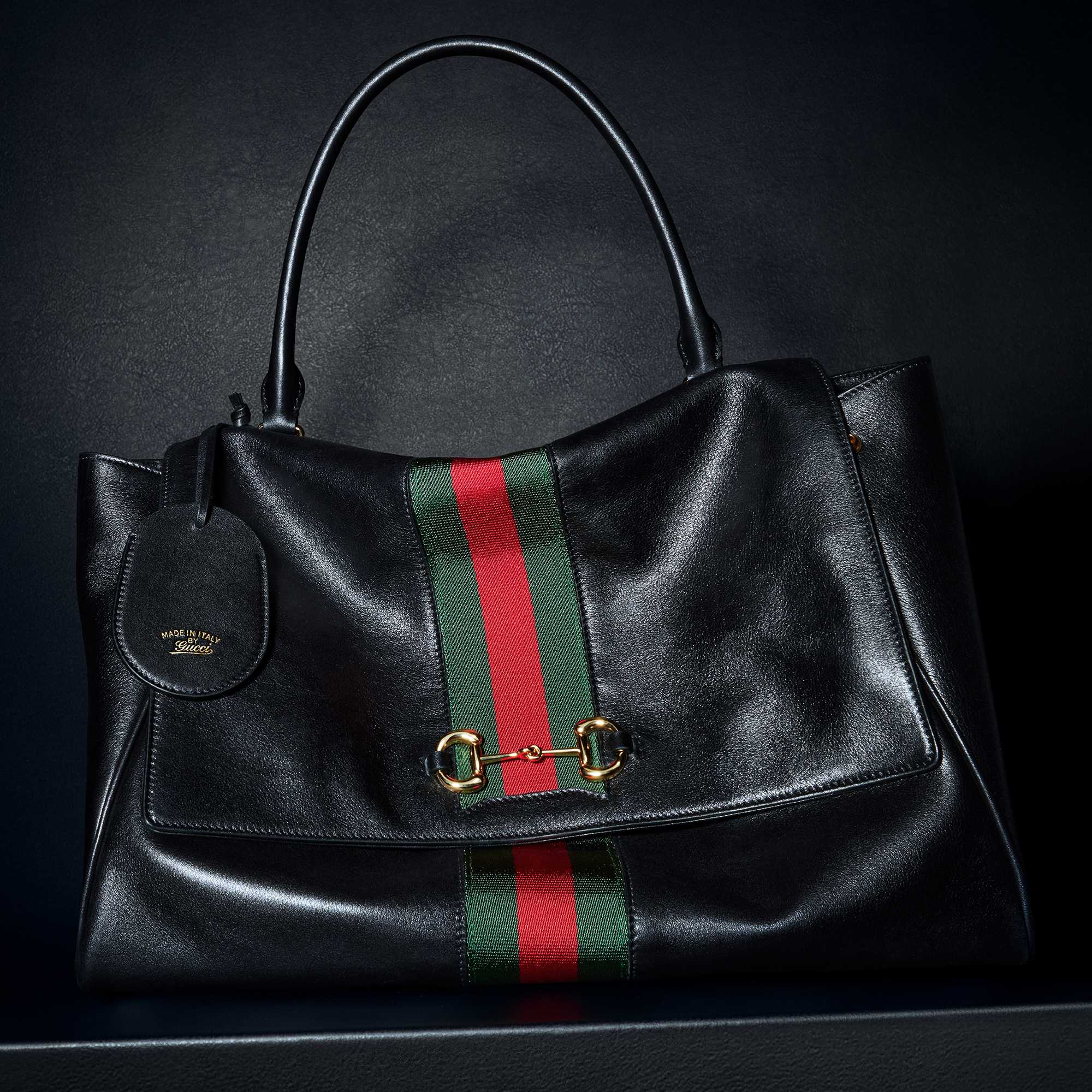 Green Gucci outfit, black bag.