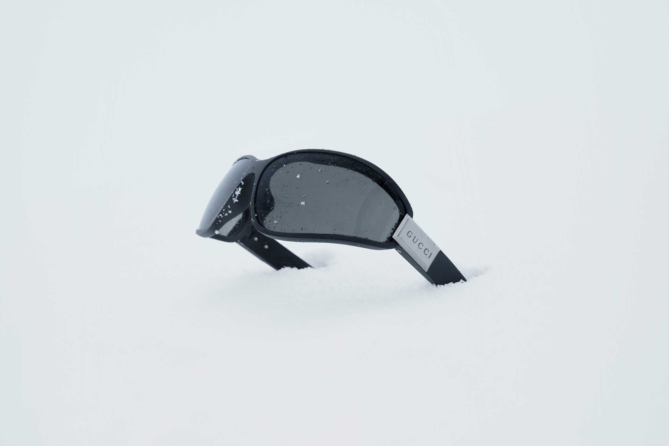 Black Gucci sunglasses on snow