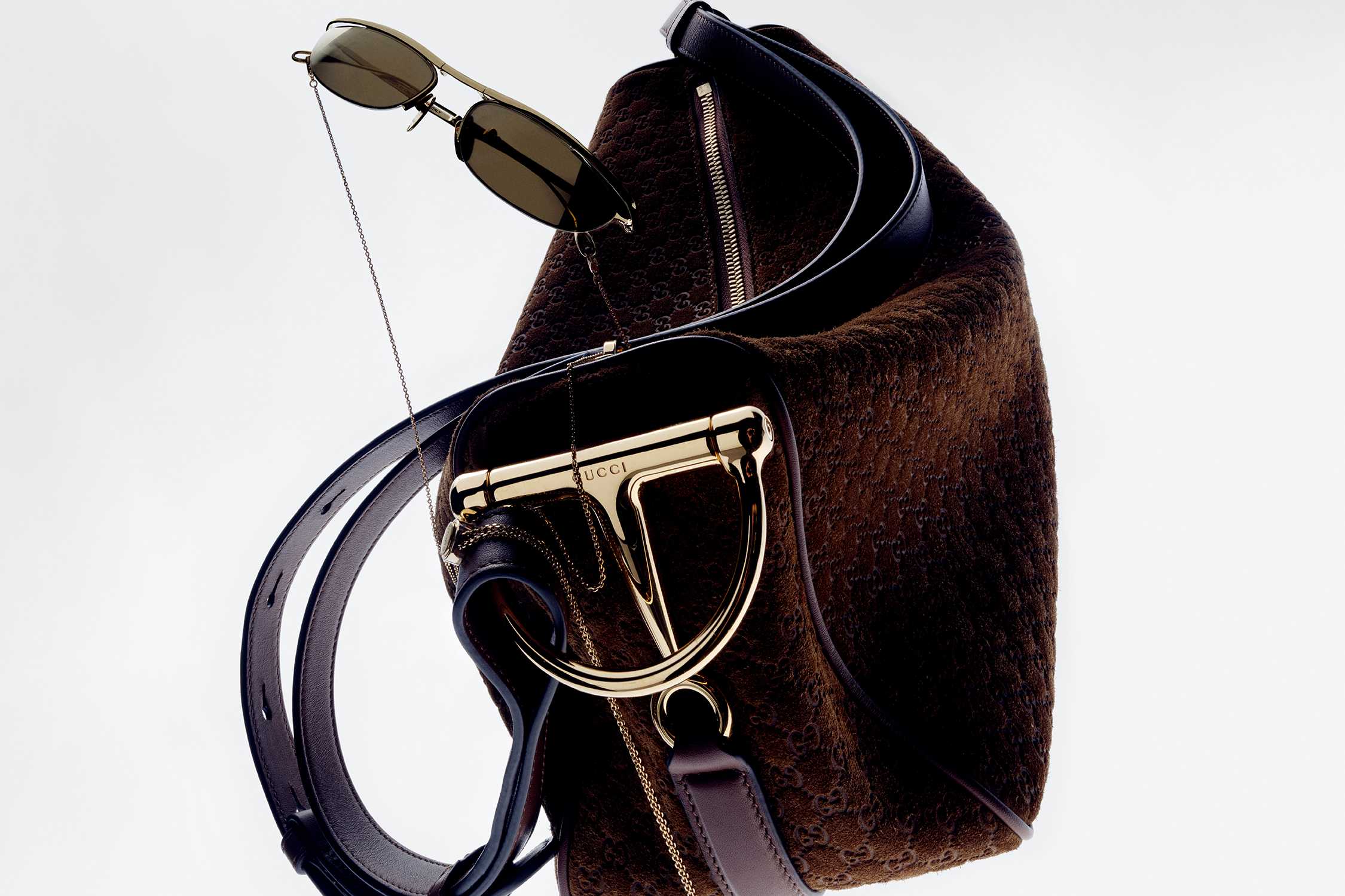 Brown Gucci bag with sunglasses.