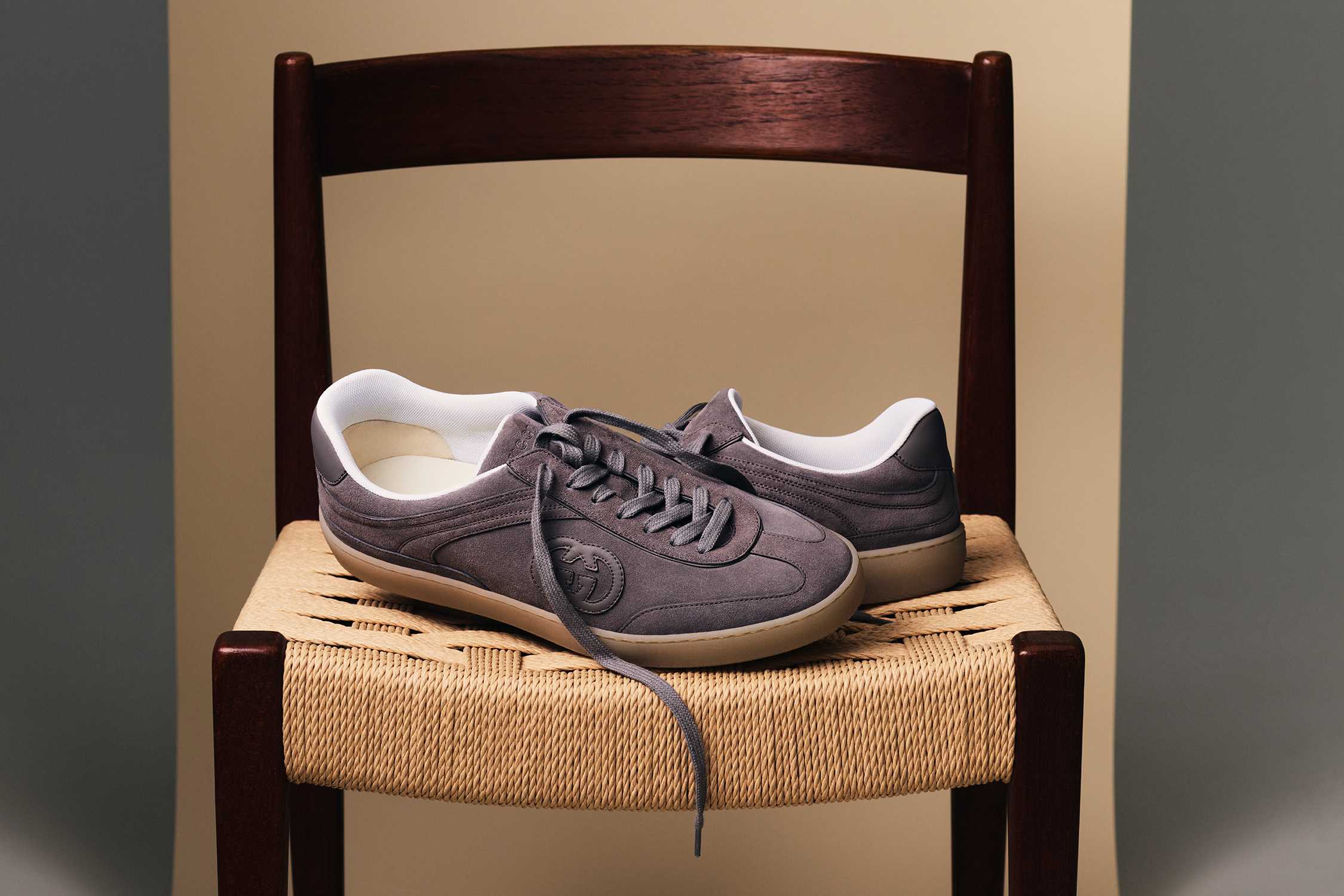 Grey G75 Gucci sneakers on chair