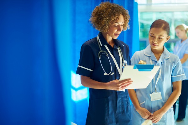 A nursing student learns during a clinical placement.