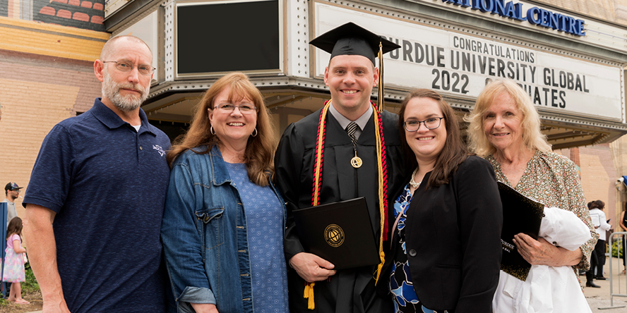 Justin Marvin celebrates with his family at Purdue University Global’s spring commencement at Indianapolis’ Old National Centre on May 21, 2022. (Purdue University photo/John Underwood)