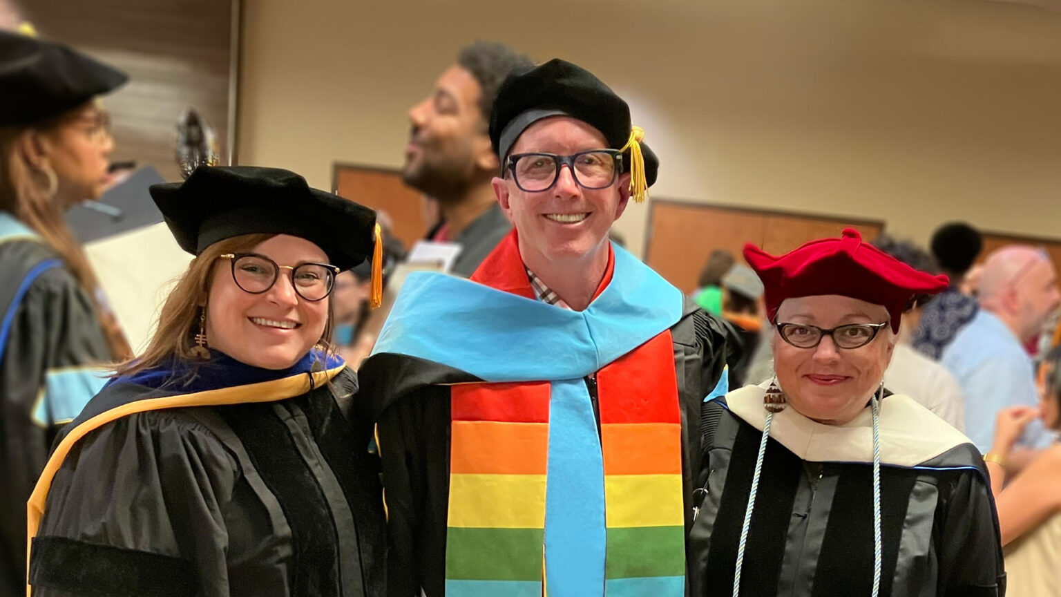 Josef Vice, middle, poses at commencement with two of his colleagues.