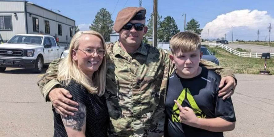 After getting a promotion, Dustin proudly celebrates with his wife and son. (Photo provided)