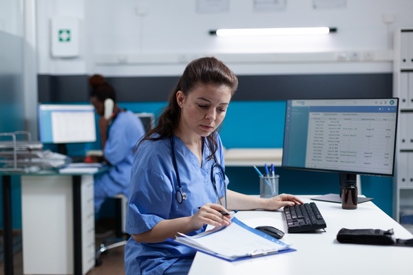A nurse reviews patient charts.