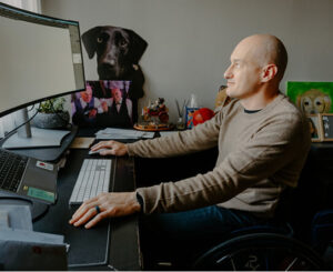 Kevin Kohn works in his home office, under the close watch of a cardboard cutout of Elsa. (Purdue University photo/Kelsey Lefever) 