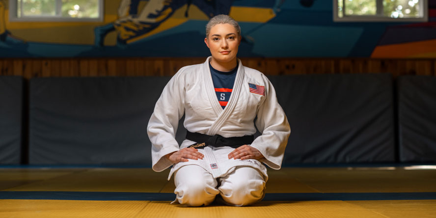 Stout-Berliner sits Seiza, a respectful pose used at the opening and closing of classes, as well as during demonstrations. (Photo credit: Purdue Global)