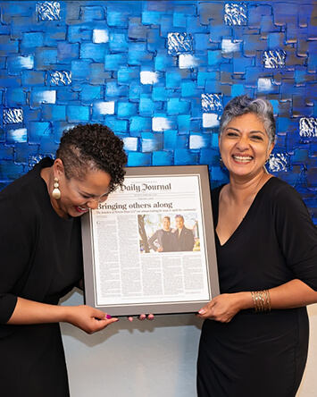 Somita celebrates the publication of a profile on her firm with her partner Zakiya J. Norton. (Photo by Steve Cotton)