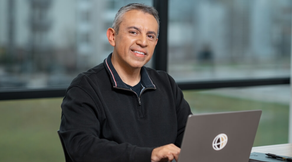 Purdue Global graduate Carlos Bonilla in cap and gown