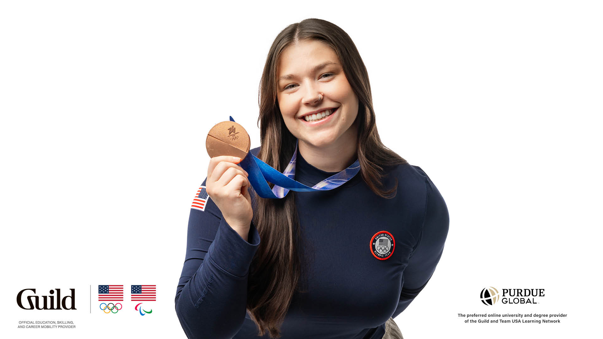 cap: U.S. Olympian Ashley Farquharson represented Team USA in luge at the Olympic Winter Games in Milano Cortina 2026 — bringing home a bronze medal. She’s also earning her bachelor’s degree in business administration with Purdue Global. (Purdue Global photo/Kelsey Lefever)
alt: Ashley, dressed in Team USA gear and standing against a white background, holds up her bronze medal.
