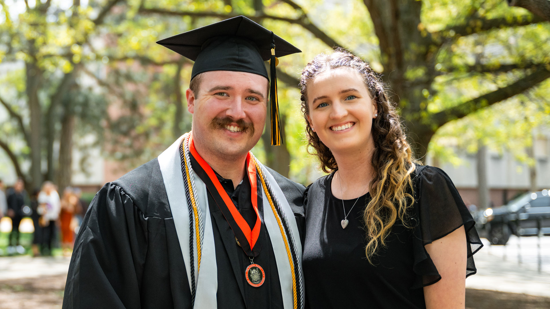 Dillon Dunn and his wife pose for a picture at Purdue Global graduation.