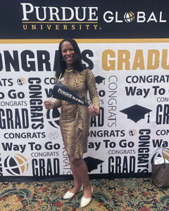 Krystal Dabon poses with Purdue University Global memorabilia at spring 2022 commencement in Indianapolis. (Photo courtesy of Krystal Dabon)