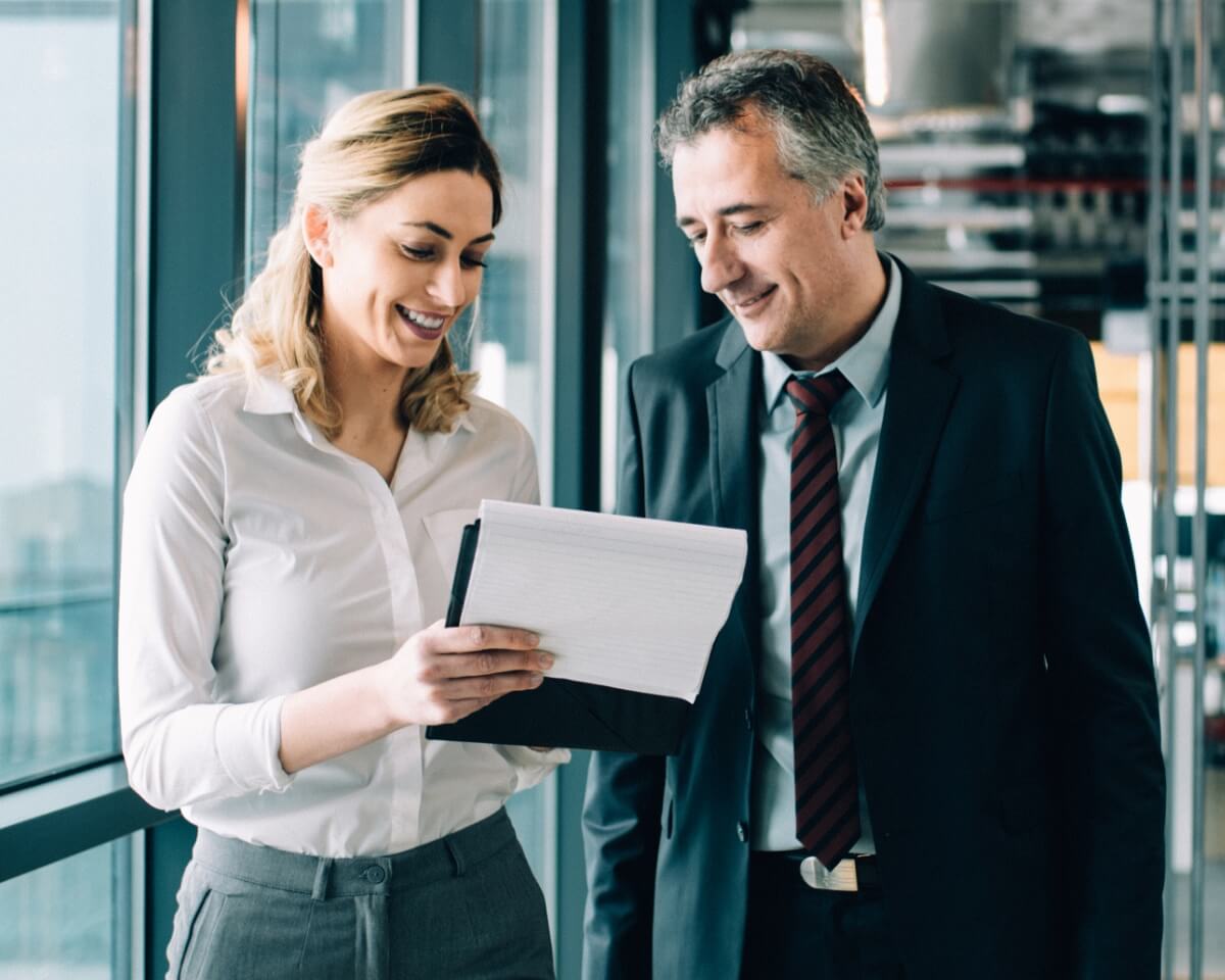 A legal professional shows documents to a colleague in an office