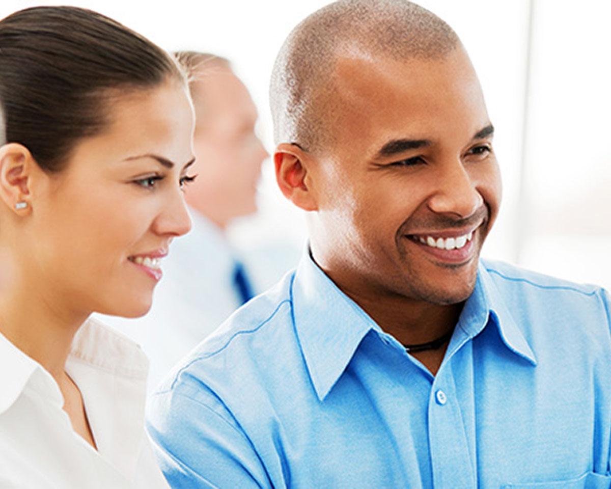 Two professionals chatting with a group